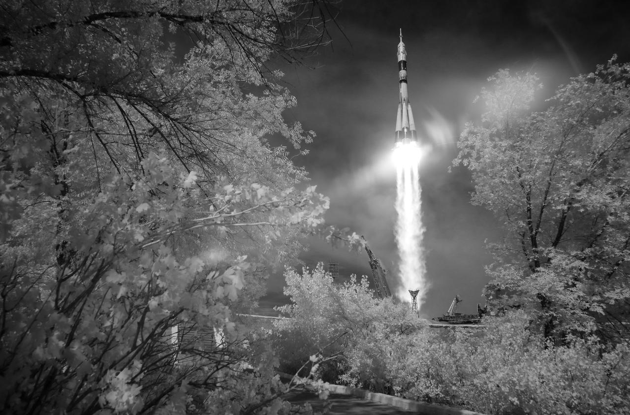 In this black and white infrared image, the Soyuz MS-09 rocket is launched with Expedition 56 Soyuz Commander Sergey Prokopyev of Roscosmos, flight engineer Serena Auñón-Chancellor of NASA, and flight engineer Alexander Gerst of ESA (European Space Agency), Wednesday, June 6, 2018 at the Baikonur Cosmodrome in Kazakhstan. Prokopyev, Auñón-Chancellor, and Gerst will spend the next six months living and working aboard the International Space Station. Photo Credit: (NASA/Joel Kowsky)