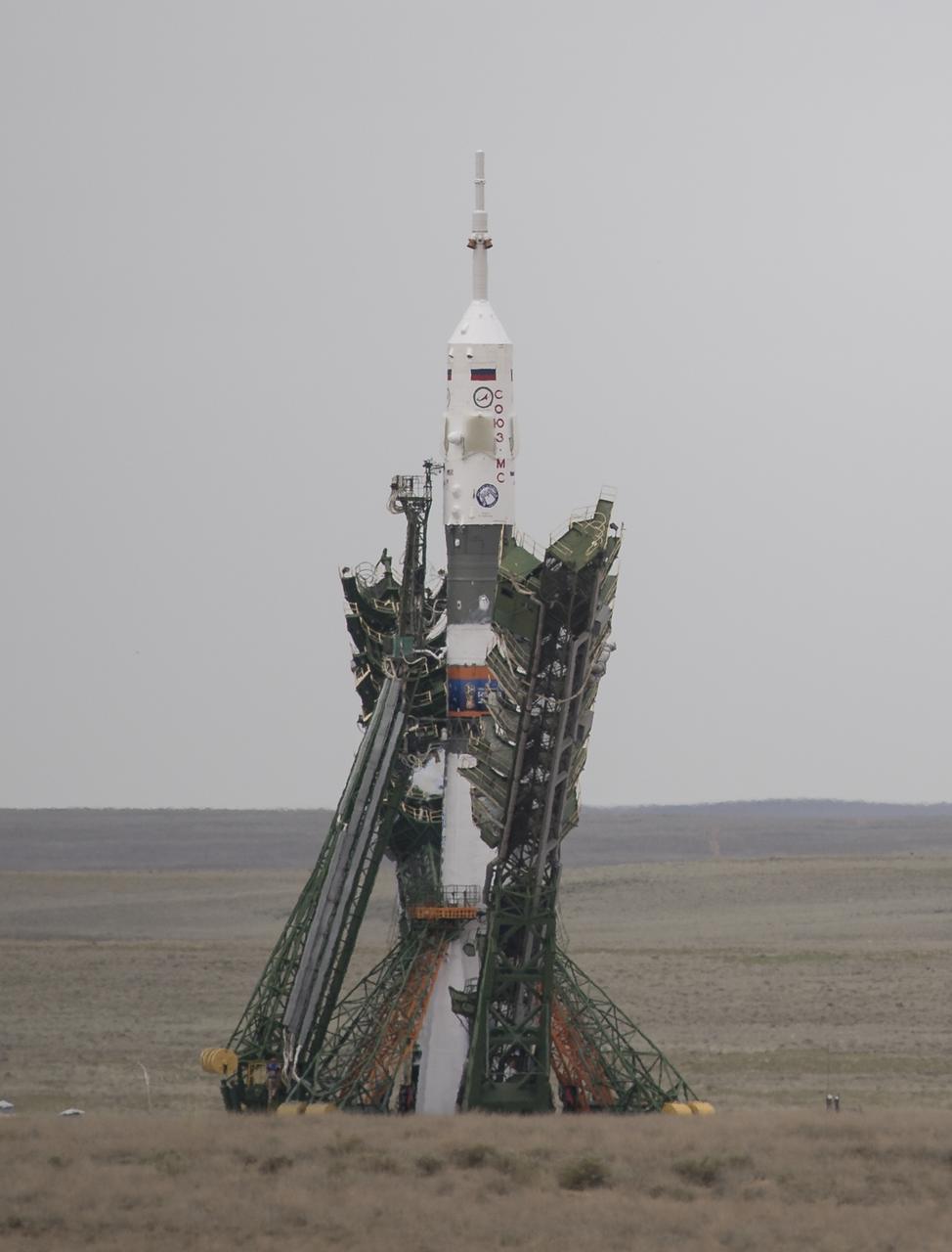 The Soyuz MS-09 rocket is seen as the gantry arms are lowered prior to launch, Wednesday, June 6, 2018 at the Baikonur Cosmodrome in Kazakhstan. Expedition 56 Soyuz Commander Sergey Prokopyev of Roscosmos, flight engineer Serena Auñón-Chancellor of NASA, and flight engineer Alexander Gerst of ESA (European Space Agency) will spend the next six months living and working aboard the International Space Station.  Photo Credit: (NASA/Joel Kowsky)
