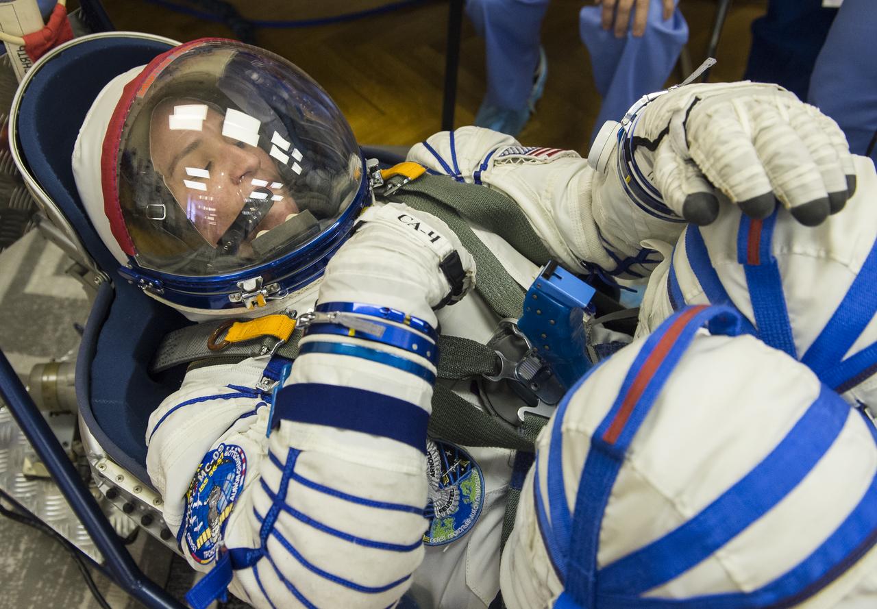 Expedition 56 flight engineer Serena Auñón-Chancellor of NASA has her Russian Sokol suit pressure checked as she and fellow crewmates, Sergey Prokopyev of Roscosmos and Alexander Gerst of ESA (European Space Agency) prepare for their Soyuz launch to the International Space Station, Wednesday, June 6, 2018 at the Baikonur Cosmodrome in Kazakhstan. Launch of the Soyuz rocket will send Auñón-Chancellor, Prokopyev, and Gerst on a six month mission aboard the International Space Station. Photo Credit: (NASA/GCTC/Andrey Shelepin)