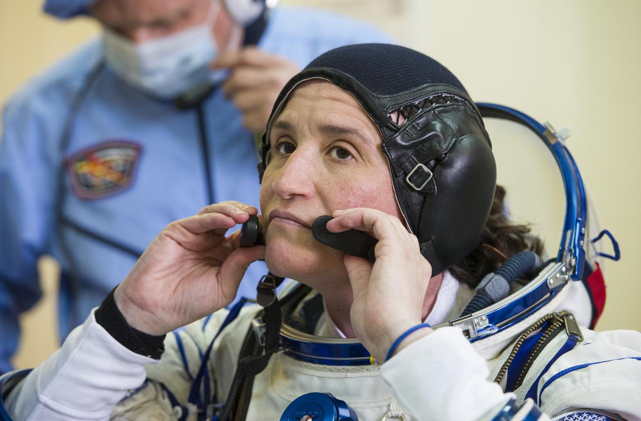 Expedition 56 flight engineer Serena Auñón-Chancellor of NASA is helped into her Russian Sokol suit as she and fellow crewmates, Sergey Prokopyev of Roscosmos and Alexander Gerst of ESA (European Space Agency) prepare for their Soyuz launch to the International Space Station Wednesday, June 6, 2018 at the Baikonur Cosmodrome in Kazakhstan. Launch of the Soyuz rocket will send Auñón-Chancellor, Prokopyev, and Gerst on a six month mission aboard the International Space Station. Photo Credit: (NASA/GCTC/Andrey Shelepin)