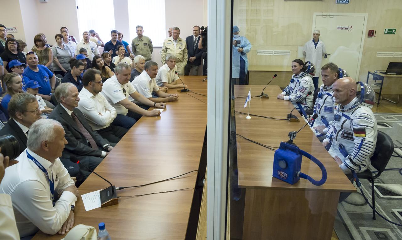 Expedition 56 flight engineer Serena Auñón-Chancellor of NASA, Soyuz Commander Sergey Prokopyev of Roscosmos, and flight engineer Alexander Gerst of ESA (European Space Agency) talk to Roscosmos and NASA management after having their Russian Sokol suits pressure checked ahead of their launch on a Soyuz rocket, Wednesday, June 6, 2018 at the Baikonur Cosmodrome in Kazakhstan. Auñón-Chancellor, Prokopyev, and Gerst launched aboard the Soyuz MS-09 spacecraft at 7:12am EDT (5:12pm Baikonur time) on June 6 to begin their journey to the International Space Station..  Photo Credit: (NASA/Victor Zelentsov)