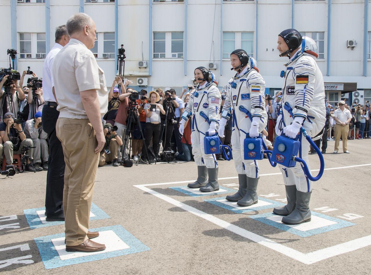 Expedition 56 flight engineer Serena Auñón-Chancellor of NASA, left, Soyuz Commander Sergey Prokopyev of Roscosmos, center, and flight engineer Alexander Gerst of ESA (European Space Agency), right, are seen as they depart Building 254 and report to mission managers a few hours before their launch, Wednesday, June 6, 2018 at the Baikonur Cosmodrome in Kazakhstan. Auñón-Chancellor, Prokopyev, and Gerst launched aboard the Soyuz MS-09 spacecraft at 7:12am EDT (5:12pm Baikonur time) on June 6 to begin their journey to the International Space Station.  Photo Credit: (NASA/Victor Zelentsov)