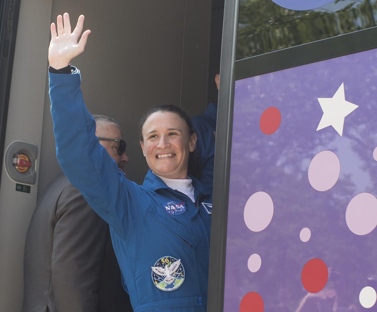 Expedition 56 flight engineer Serena Auñón-Chancellor of NASA waves farewell to family and friends as she boards a bus with fellow crewmembers Soyuz Commander Sergey Prokopyev of Roscosmos and flight engineer Alexander Gerst of ESA (European Space Agency) to depart the Cosmonaut Hotel to suit-up for their Soyuz launch to the International Space Station, Wednesday, June 6, 2018 in Baikonur, Kazakhstan. Auñón-Chancellor, Prokopyev, and Gerst launched aboard the Soyuz MS-09 spacecraft at 7:12am EDT (5:12pm Baikonur time) on June 6 to begin their journey to the International Space Station. Photo Credit: (NASA/Joel Kowsky)