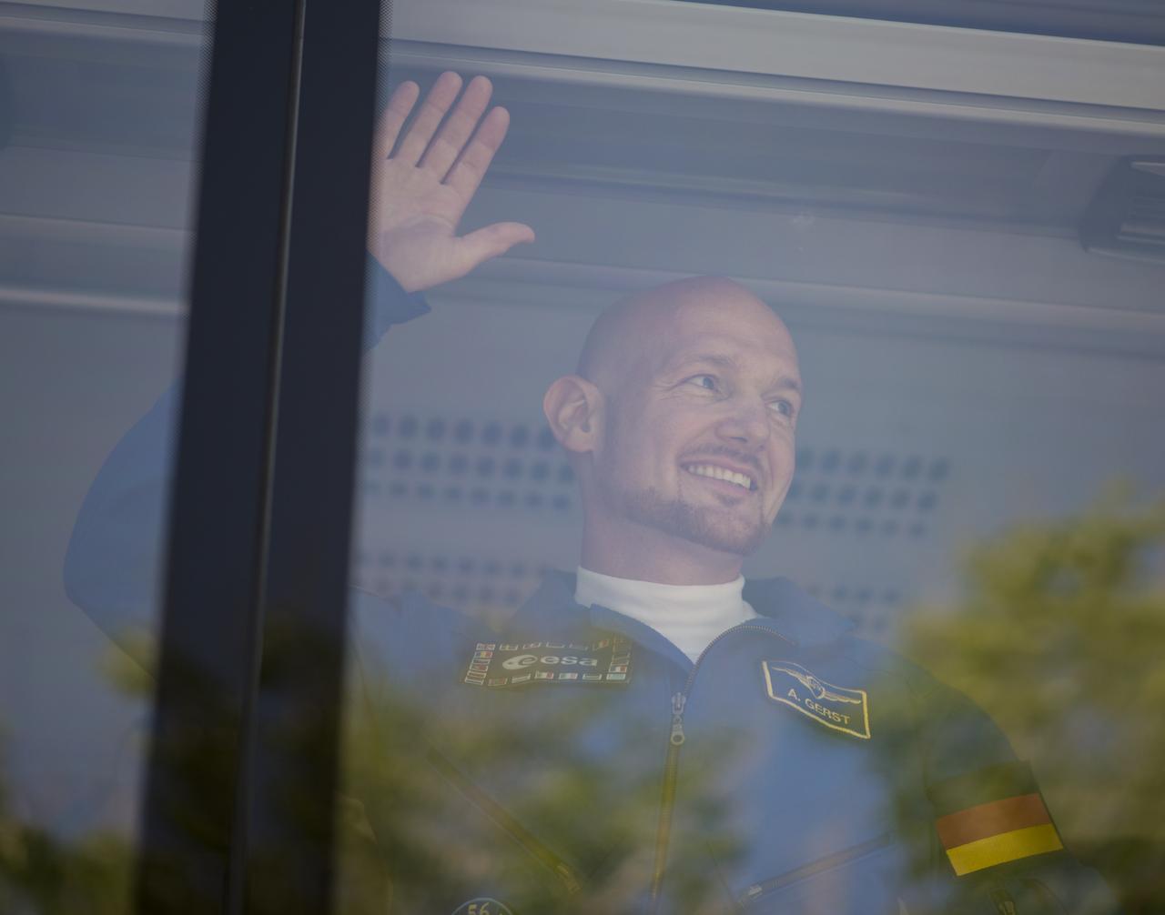 Expedition 56 flight engineer Alexander Gerst of ESA (European Space Agency) waves farewell to family and friends as he and fellow crewmates flight engineer Serena Auñón-Chancellor of NASA and Soyuz Commander Sergey Prokopyev of Roscosmos depart the Cosmonaut Hotel to suit-up for their Soyuz launch to the International Space Station, Wednesday, June 6, 2018 in Baikonur, Kazakhstan. Auñón-Chancellor, Prokopyev, and Gerst launched aboard the Soyuz MS-09 spacecraft at 7:12am EDT (5:12pm Baikonur time) on June 6 to begin their journey to the International Space Station.  Photo Credit: (NASA/Joel Kowsky)