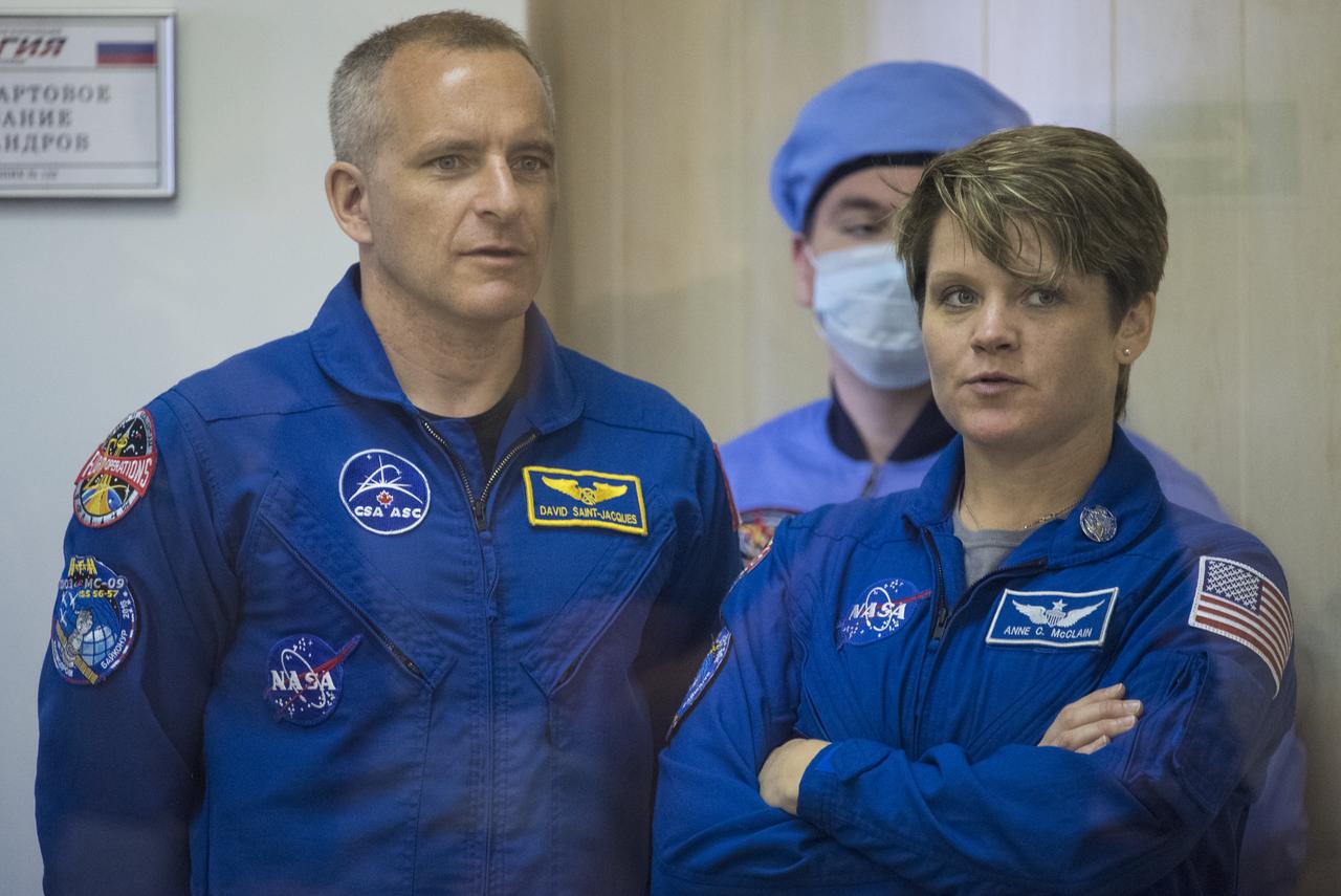 Expedition 56 backup crewmembers David Saint-Jacques of the Canadian Space Agency, left, and Anne McClain of NASA are seen as prime crewmembers Soyuz Commander Sergey Prokopyev of Roscosmos, flight engineer Serena Auñón-Chancellor of NASA, and flight engineer Alexander Gerst of ESA (European Space Agency) prepare to have their Russian Sokol suits pressure checked in preparation for launch aboard the Soyuz MS-09 spacecraft, Wednesday, June 6, 2018 at the Baikonur Cosmodrome in Kazakhstan. launched aboard the Soyuz MS-09 spacecraft at 7:12am EDT (5:12pm Baikonur time) on June 6 to begin their journey to the International Space Station. Photo Credit: (NASA/Joel Kowsky)