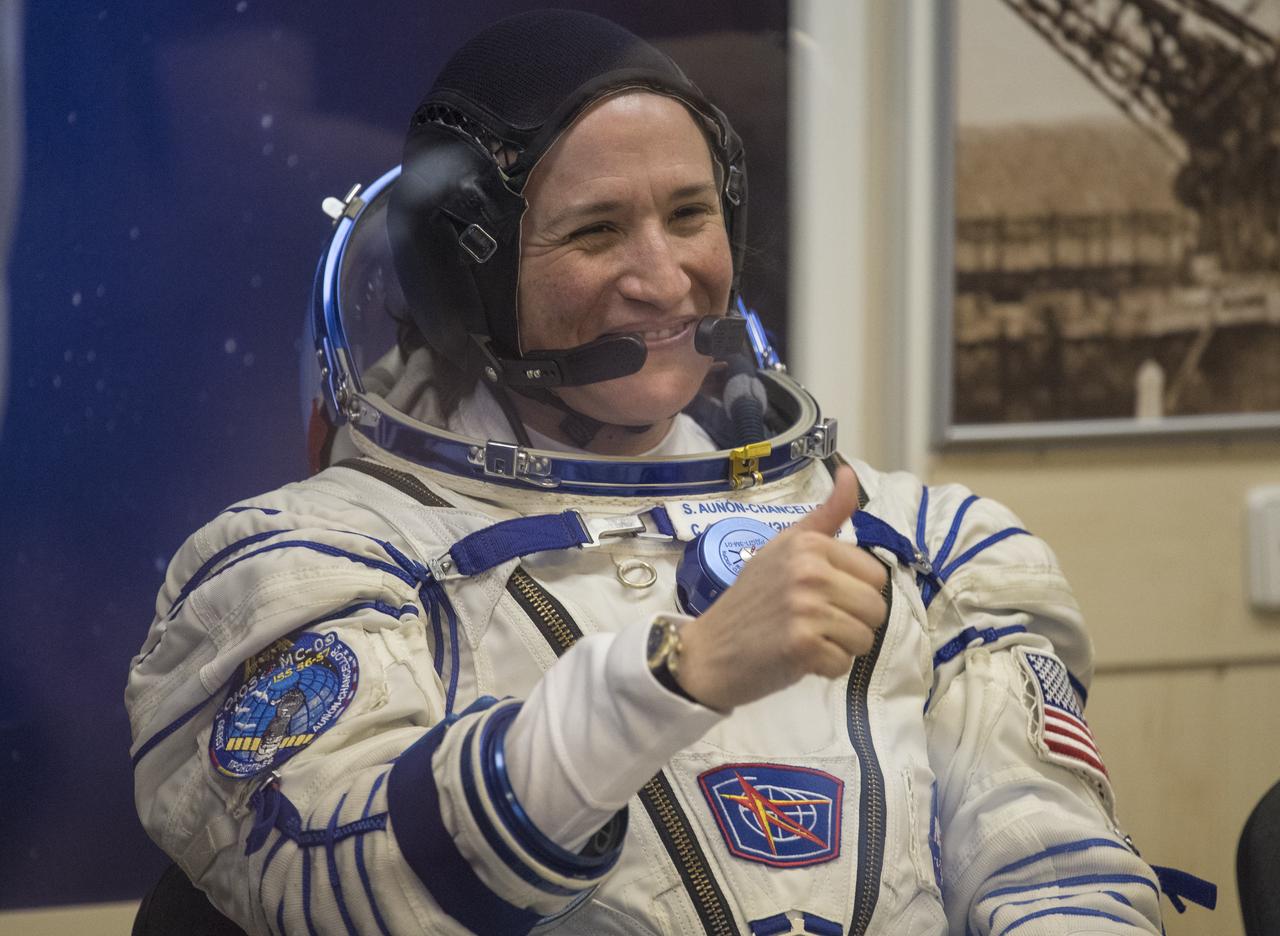 Expedition 56 flight engineer Serena Auñón-Chancellor of NASA gives a thumbs up to family and friends as she waits to have her Russian Sokol suit pressure checked in preparation for launch aboard the Soyuz MS-09 spacecraft, Wednesday, June 6, 2018 at the Baikonur Cosmodrome in Kazakhstan. Auñón-Chancellor, Sergey Prokopyev of Roscosmos, and Alexander Gerst of ESA (European Space Agency) launched aboard the Soyuz MS-09 spacecraft at 7:12am EDT (5:12pm Baikonur time) on June 6 to begin their journey to the International Space Station. Photo Credit: (NASA/Joel Kowsky)