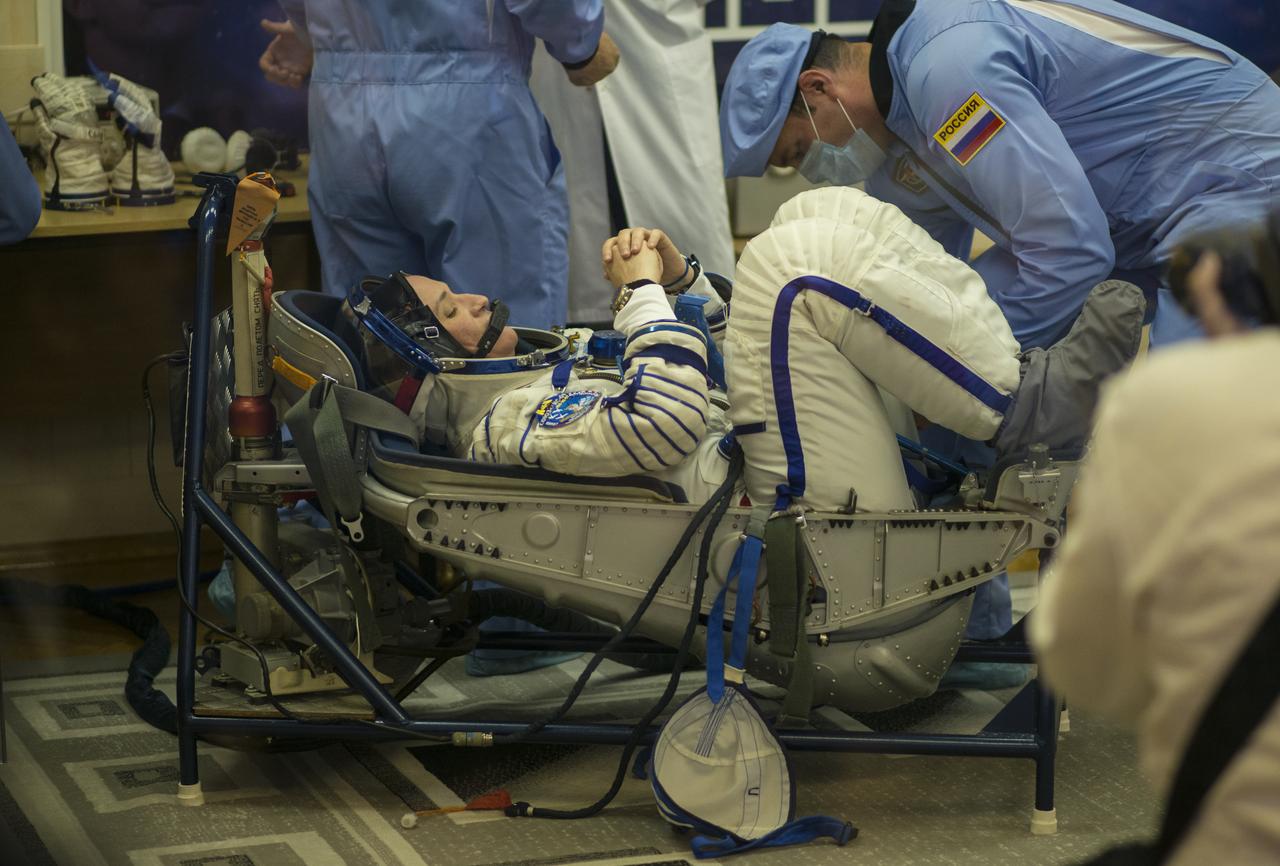 Expedition 56 flight engineer Serena Auñón-Chancellor of NASA prepares to have her Russian Sokol suit pressure checked in preparation for launch aboard the Soyuz MS-09 spacecraft, Wednesday, June 6, 2018 at the Baikonur Cosmodrome in Kazakhstan. Auñón-Chancellor, flight engineer Alexander Gerst of ESA (European Space Agency) and Soyuz Commander Sergey Prokopyev of Roscosmos launched aboard the Soyuz MS-09 spacecraft at 7:12am EDT (5:12pm Baikonur time) on June 6 to begin their journey to the International Space Station. Photo Credit: (NASA/Joel Kowsky)