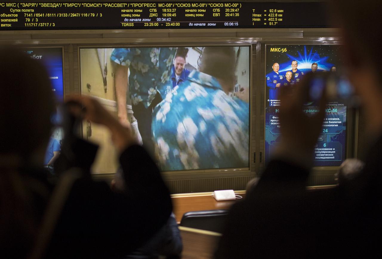 Expedition 56 flight engineer Serena Auñón-Chancellor of NASA is seen after the hatches were opened between the Soyuz MS-09 spacecraft and the International Space Station on screens at the Moscow Mission Control Center in Korolev, Russia a few hours after the Soyuz MS-09 docked to the International Space Station on Friday, June 8, 2018. Hatches were opened at 11:17am EDT (6:17pm Moscow time) and Auñón-Chancellor, Alexander Gerst of ESA (European Space Agency), and Sergey Prokopyev of Roscosmos joined Expedition 56 Commander Drew Feustel of NASA, Ricky Arnold of NASA, and Oleg Artemyev of Roscosmos onboard the orbiting laboratory.  Photo Credit: (NASA/Joel Kowsky)