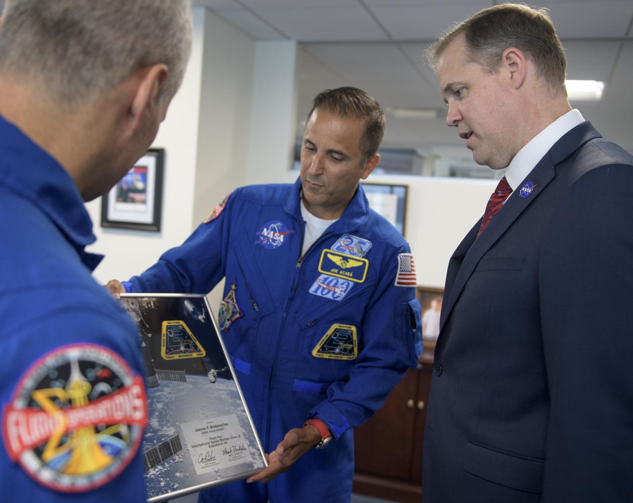 NASA Administrator Jim Bridenstine, right, meets with Expedition 54 NASA astronauts Mark Vande Hei, left, and Joe Acaba during their Expedition 54 post flight, Wednesday, June 13, 2018 at NASA Headquarters, Washington. Photo Credit: (NASA/Bill Ingalls)