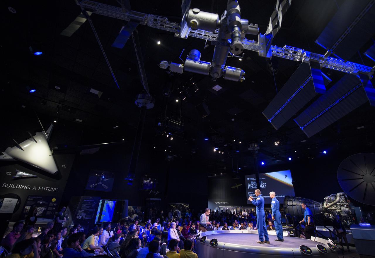 NASA astronauts Joe Acaba, left, and Mark Vande Hei right, answer audience questions with the Smithsonian's Marty Kelsey, center, during "What's New in Aerospace," Thursday, June 14, 2018 at the Smithsonian National Air and Space Museum in Washington. Acaba and Vande Hei answered questions from the audience and spoke about their experiences aboard the International Space Station for 168 days as part of Expedition 53 and 54. Photo Credit: (NASA/Joel Kowsky)