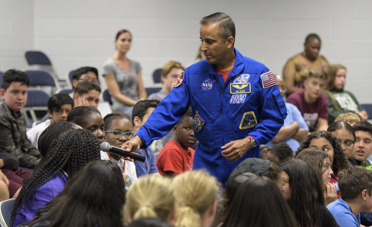 NASA astronaut Joe Acaba listens to a question from a student during a presentation at Walt Whitman Middle School, Thursday, June 14, 2018 in Alexandria, Va. Acaba and astronaut Mark Vande Hei answered questions from the audience and spoke about their experiences aboard the International Space Station for 168 days as part of Expedition 53 and 54. Photo Credit: (NASA/Joel Kowsky)