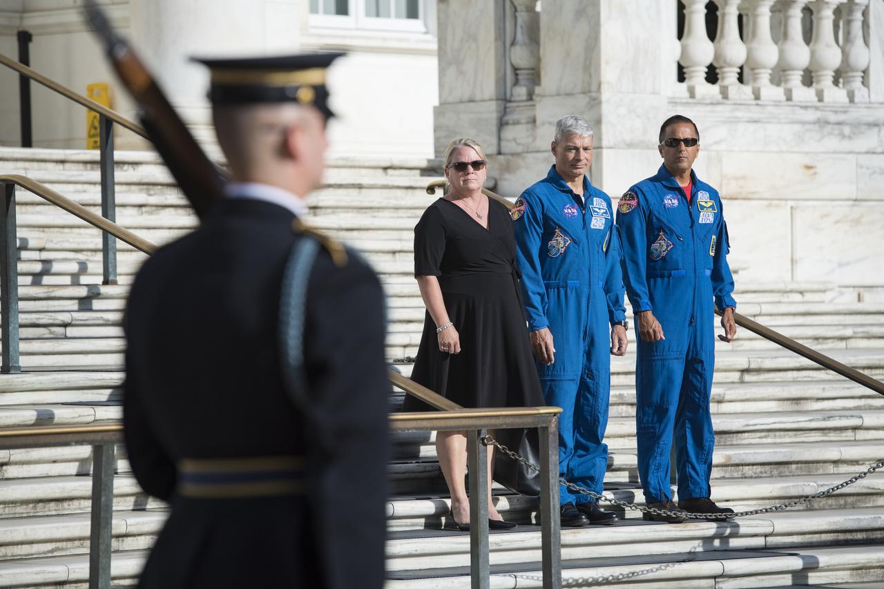 NASA astronaut Mark Vande Hei, center, his wife Julie, left, and NASA astronaut Joe Acaba witness the changing of the guards at the Tomb of the Unknown soldier, Friday, June 15, 2018 at Arlington National Cemetery in Arlington, Va. Photo Credit: (NASA/Aubrey Gemignani)