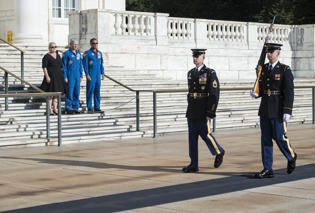 NASA astronaut Mark Vande Hei, center, his wife Julie, left, and NASA astronaut Joe Acaba witness the changing of the guards at the Tomb of the Unknown soldier, Friday, June 15, 2018 at Arlington National Cemetery in Arlington, Va. Photo Credit: (NASA/Aubrey Gemignani)
