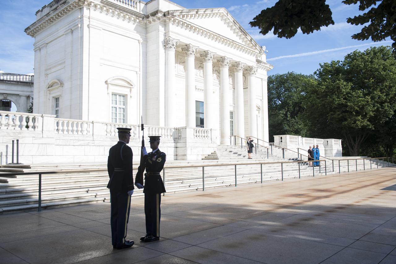NASA astronaut Mark Vande Hei, center, his wife Julie, left, and NASA astronaut Joe Acaba witness the changing of the guards at the Tomb of the Unknown soldier, Friday, June 15, 2018 at Arlington National Cemetery in Arlington, Va. Photo Credit: (NASA/Aubrey Gemignani)