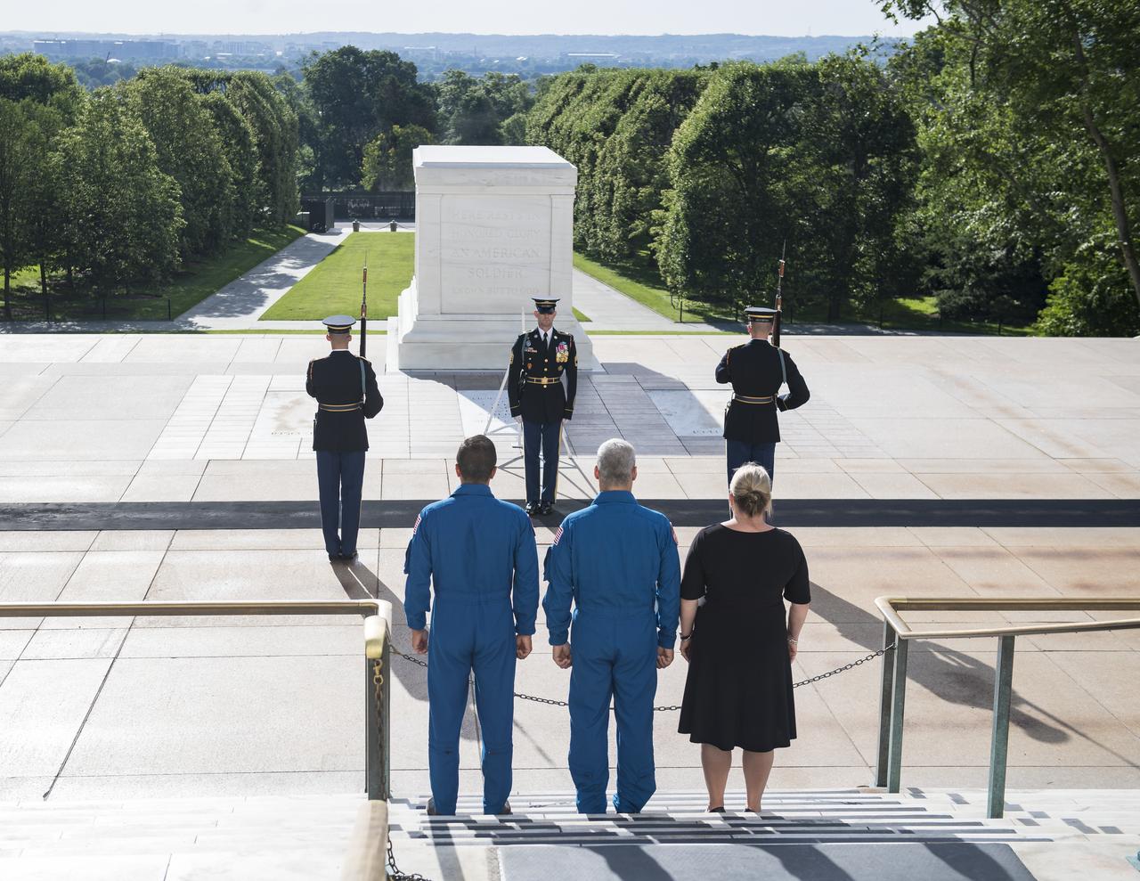 NASA astronaut Mark Vande Hei, center, his wife Julie, right, and NASA astronaut Joe Acaba witness the changing of the guards at the Tomb of the Unknown soldier, Friday, June 15, 2018 at Arlington National Cemetery in Arlington, Va. Photo Credit: (NASA/Aubrey Gemignani)