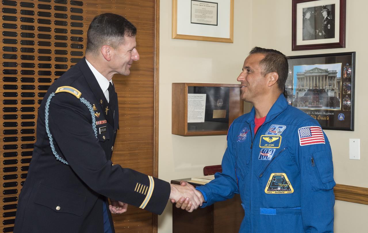 NASA astronaut Joe Acaba, right, shakes hands with Lieutenant Colonel Jeffery Todd Burroughs, battalion commander, Old Guard, Friday, June 15, 2018 at the Arlington National Cemetery in Arlington, Va. Photo Credit: (NASA/Aubrey Gemignani)