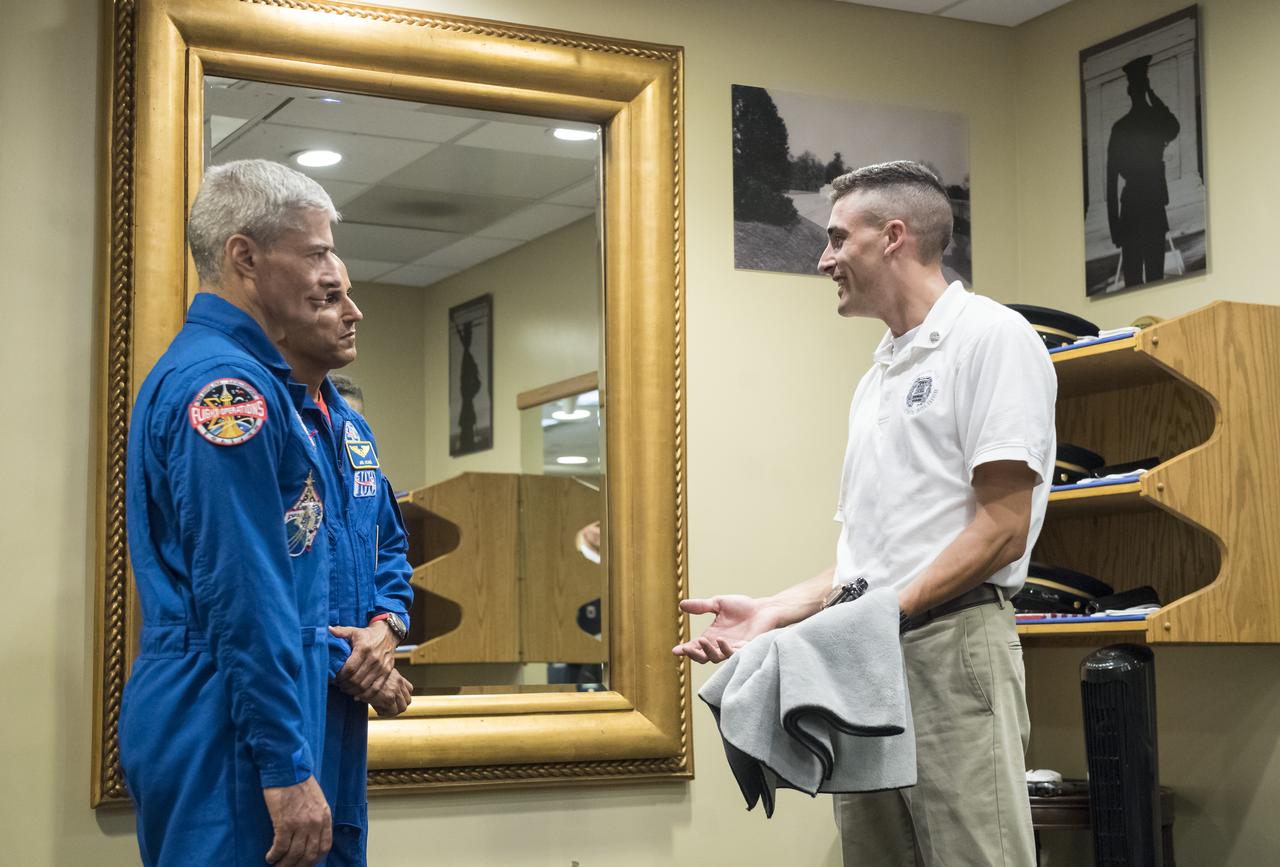 NASA astronauts Mark Vande Hei, left, and Joe Acaba, center, listen as Sergeant Craig Hudson explains the tradition of the Honor Guard at the Tomb of the Unknowns, Friday, June 15, 2018 at the Arlington National Cemetery in Arlington, Va. Photo Credit: (NASA/Aubrey Gemignani)