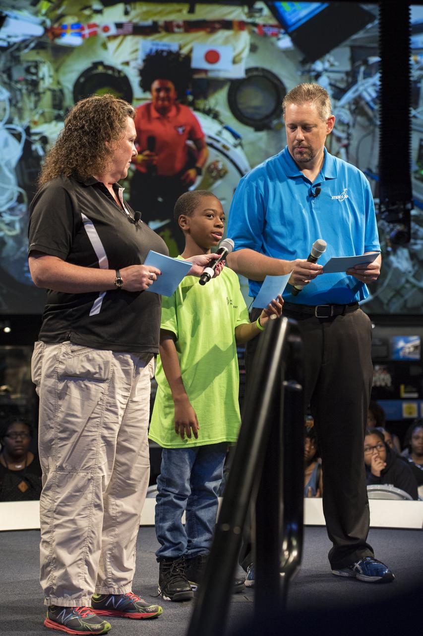 A student asks NASA astronaut Serena Auñon-Chancellor a question during a live downlink with the International Space Station (ISS), Wednesday, June 27, 2018 at Smithsonian's National Air and Space Museum in Washington. Serena is part of the Expedition 56/57 crew that launched to the ISS June 6, 2018. Photo Credit: (NASA/Aubrey Gemignani)