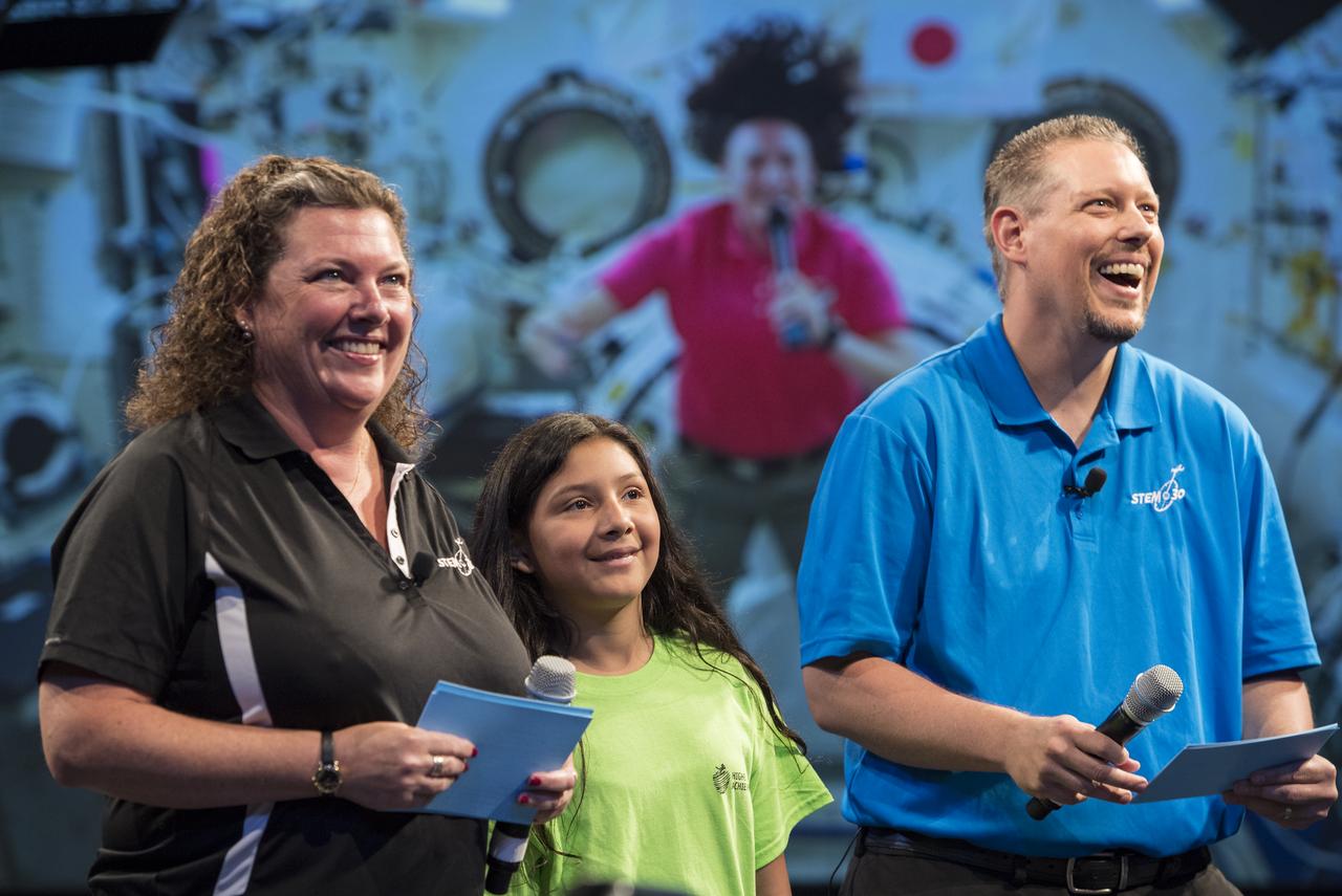 A student asks NASA astronaut Serena Auñon-Chancellor a question during a live downlink with the International Space Station (ISS), Wednesday, June 27, 2018 at Smithsonian's National Air and Space Museum in Washington. Serena is part of the Expedition 56/57 crew that launched to the ISS June 6, 2018. Photo Credit: (NASA/Aubrey Gemignani)