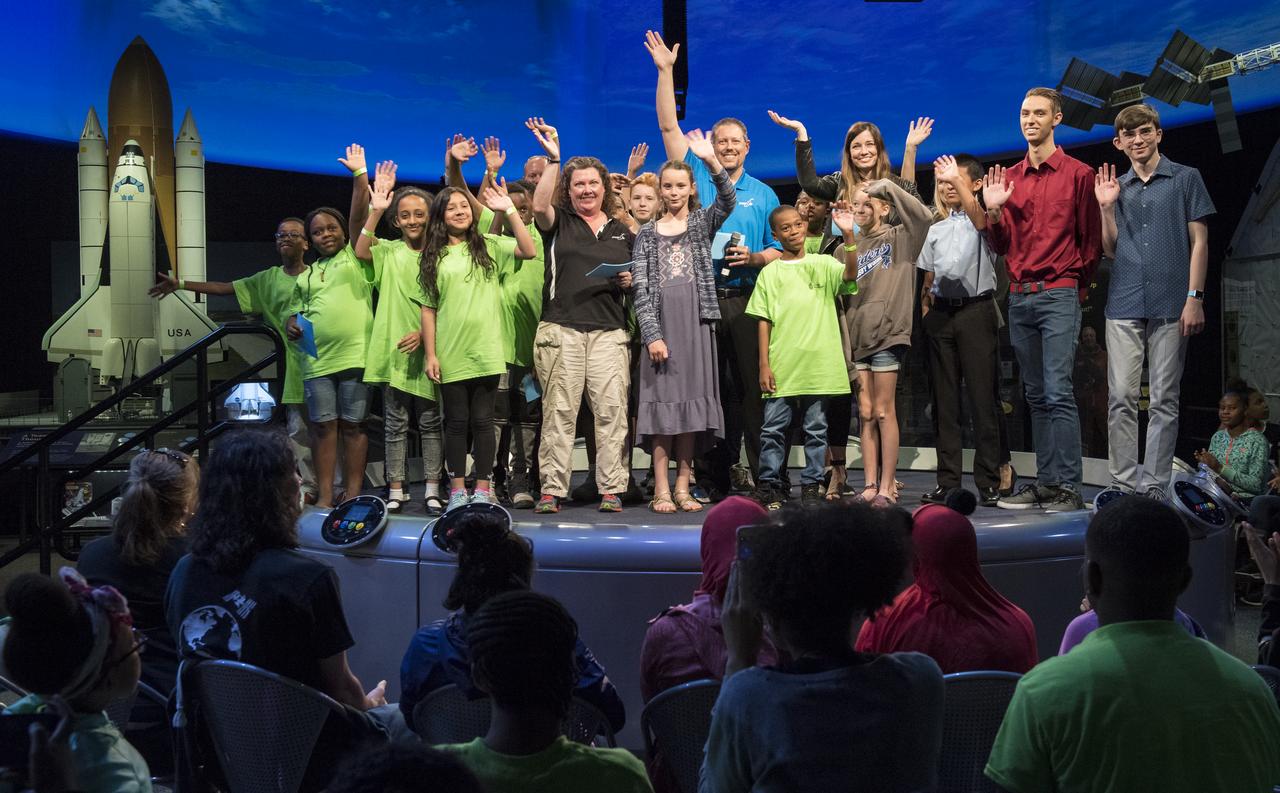 Students and Future Engineers "Two for the Crew" winners wave goodbye at the conclusion of a STEM in 30 event, Wednesday, June 27, 2018 at Smithsonian's National Air and Space Museum in Washington. During the event, NASA astronaut Serena Auñon-Chancellor spoke to students while onboard the International Space Station (ISS), during a live downlink. Photo Credit: (NASA/Aubrey Gemignani)