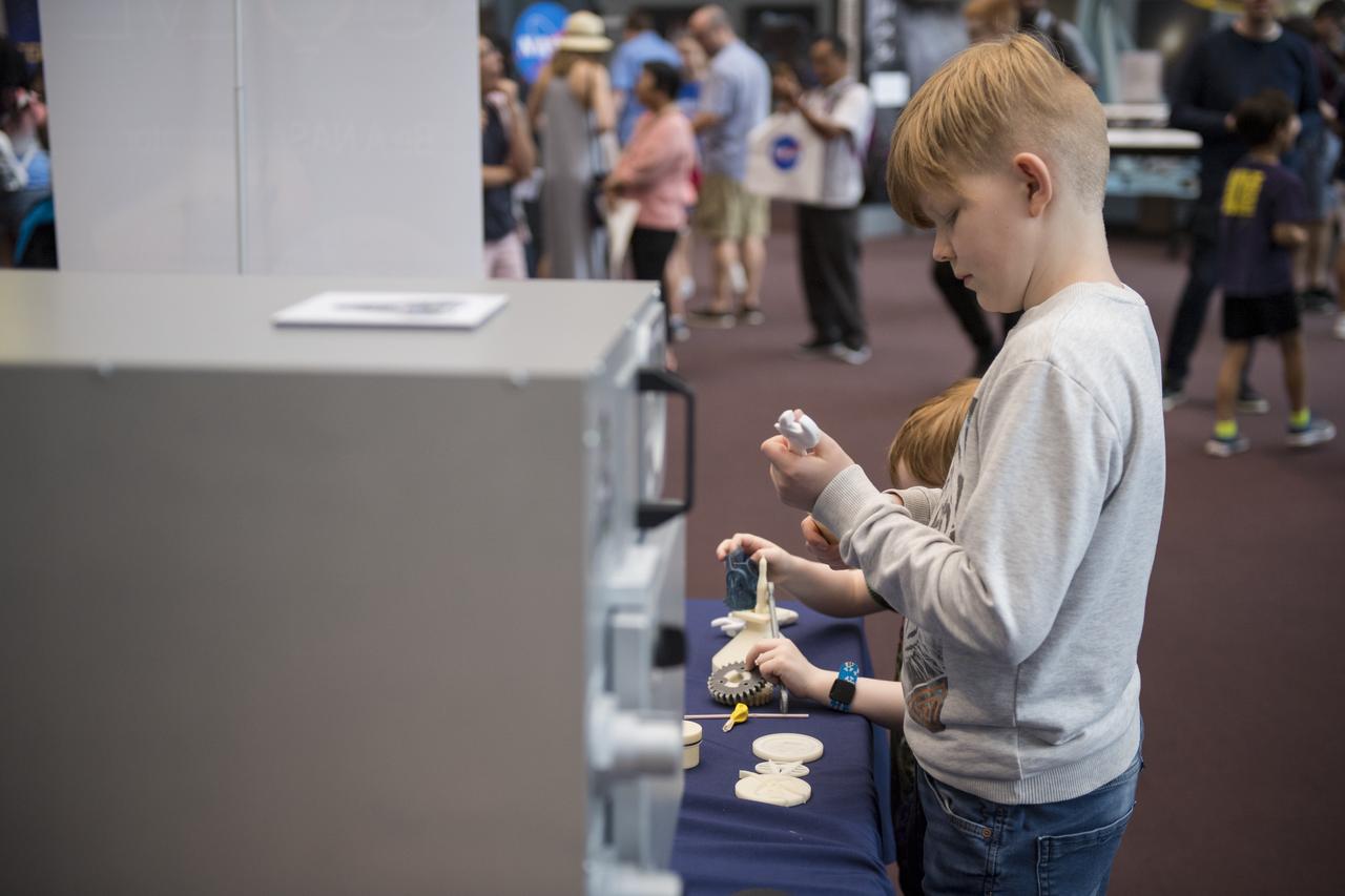 Visitors explore the activities in the Space Race Gallery at Smithsonian's National Air and Space Museum, Wednesday, June 27, 2018 in Washington. Photo Credit: (NASA/Aubrey Gemignani)