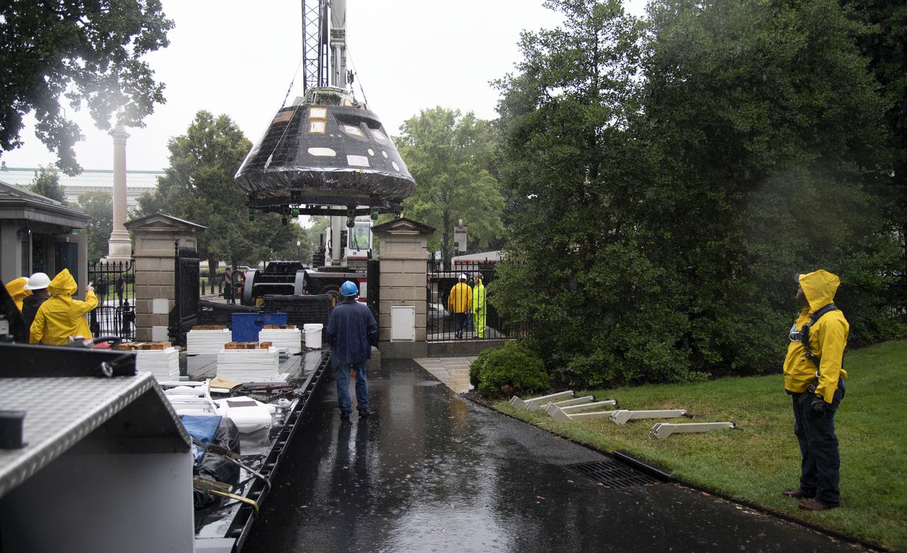NASA's Orion spacecraft that flew Exploration Flight Test-1 on Dec. 5, 2014 is seen while being lifted over a gate and onto the South Lawn of the White House, Saturday, July 21, 2018 in Washington, DC. Lockheed Martin, NASA’s prime contractor for Orion, began manufacturing the Orion crew module in 2011 and delivered it in July 2012 to NASA's Kennedy Space Center where final assembly, integration and testing was completed. More than 1,000 companies across the country manufactured or contributed elements to the spacecraft. Photo Credit: (NASA/Joel Kowsky)