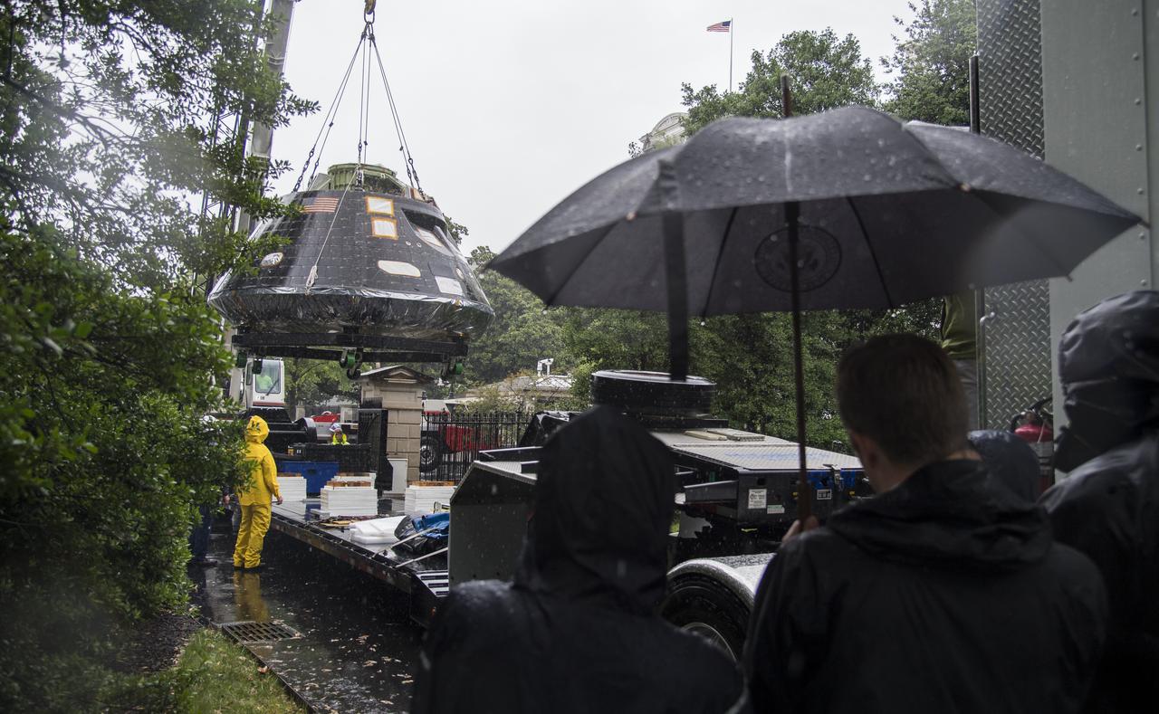NASA's Orion spacecraft that flew Exploration Flight Test-1 on Dec. 5, 2014 is seen while being lifted over a gate and onto the South Lawn of the White House, Saturday, July 21, 2018 in Washington, DC. Lockheed Martin, NASA’s prime contractor for Orion, began manufacturing the Orion crew module in 2011 and delivered it in July 2012 to NASA's Kennedy Space Center where final assembly, integration and testing was completed. More than 1,000 companies across the country manufactured or contributed elements to the spacecraft. Photo Credit: (NASA/Joel Kowsky)