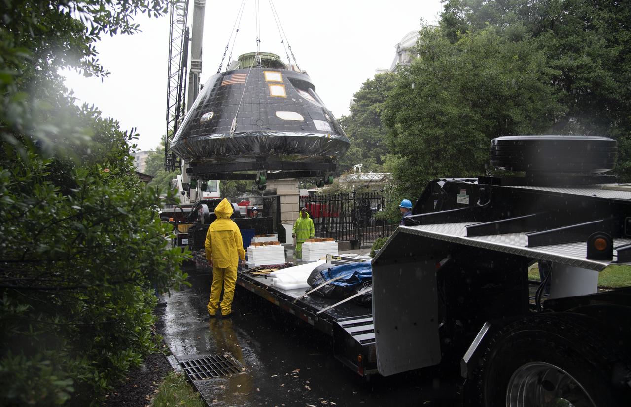 NASA's Orion spacecraft that flew Exploration Flight Test-1 on Dec. 5, 2014 is seen while being lifted over a gate and onto the South Lawn of the White House, Saturday, July 21, 2018 in Washington, DC. Lockheed Martin, NASA’s prime contractor for Orion, began manufacturing the Orion crew module in 2011 and delivered it in July 2012 to NASA's Kennedy Space Center where final assembly, integration and testing was completed. More than 1,000 companies across the country manufactured or contributed elements to the spacecraft. Photo Credit: (NASA/Joel Kowsky)