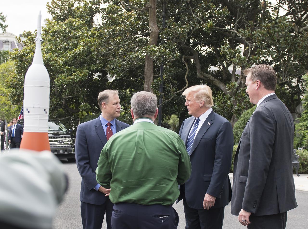 NASA Administrator Jim Bridenstine, left, speaks with President Donald Trump, NASA Chief Financial Officer, Jeff DeWitt, right, and Orion Program Manager, W. Michael Hawes, front, about NASA's Orion spacecraft that is currently on display on the south lawn of the White House as part of the Made in America showcase, at the White House, Monday, July 23, 2018 in Washington. Lockheed Martin, NASA’s prime contractor for Orion, began manufacturing the Orion crew module in 2011 and delivered it in July 2012 to NASA's Kennedy Space Center where final assembly, integration and testing was completed. The successful launch of Orion on the Exploration Flight Test-1 was on Dec. 5, 2014. More than 1,000 companies across the country manufactured or contributed elements to the spacecraft. Photo Credit: (NASA/Aubrey Gemignani)