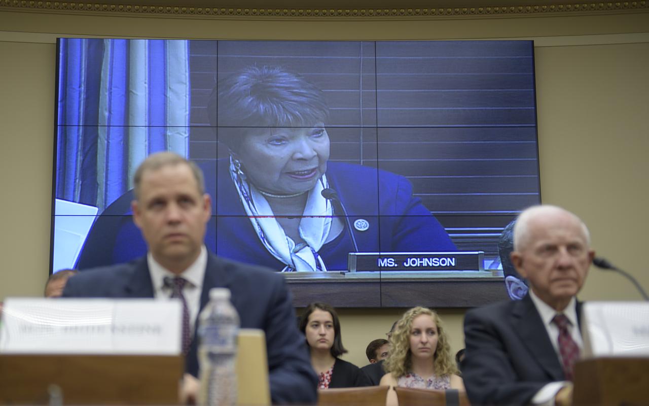 Rep. Eddie Bernice Johnson, D-Texas is seen on a monitor as she questions witnesses; NASA Administrator Jim Bridenstine, left, and Tom Young, chairman, JWST Independent Review Board, during a House Committee on Science, Space, and Technology hearing on the James Webb Space Telescope, Wednesday, July 25, 2018 at the Rayburn House Office Building in Washington. Photo Credit: (NASA/Bill Ingalls)