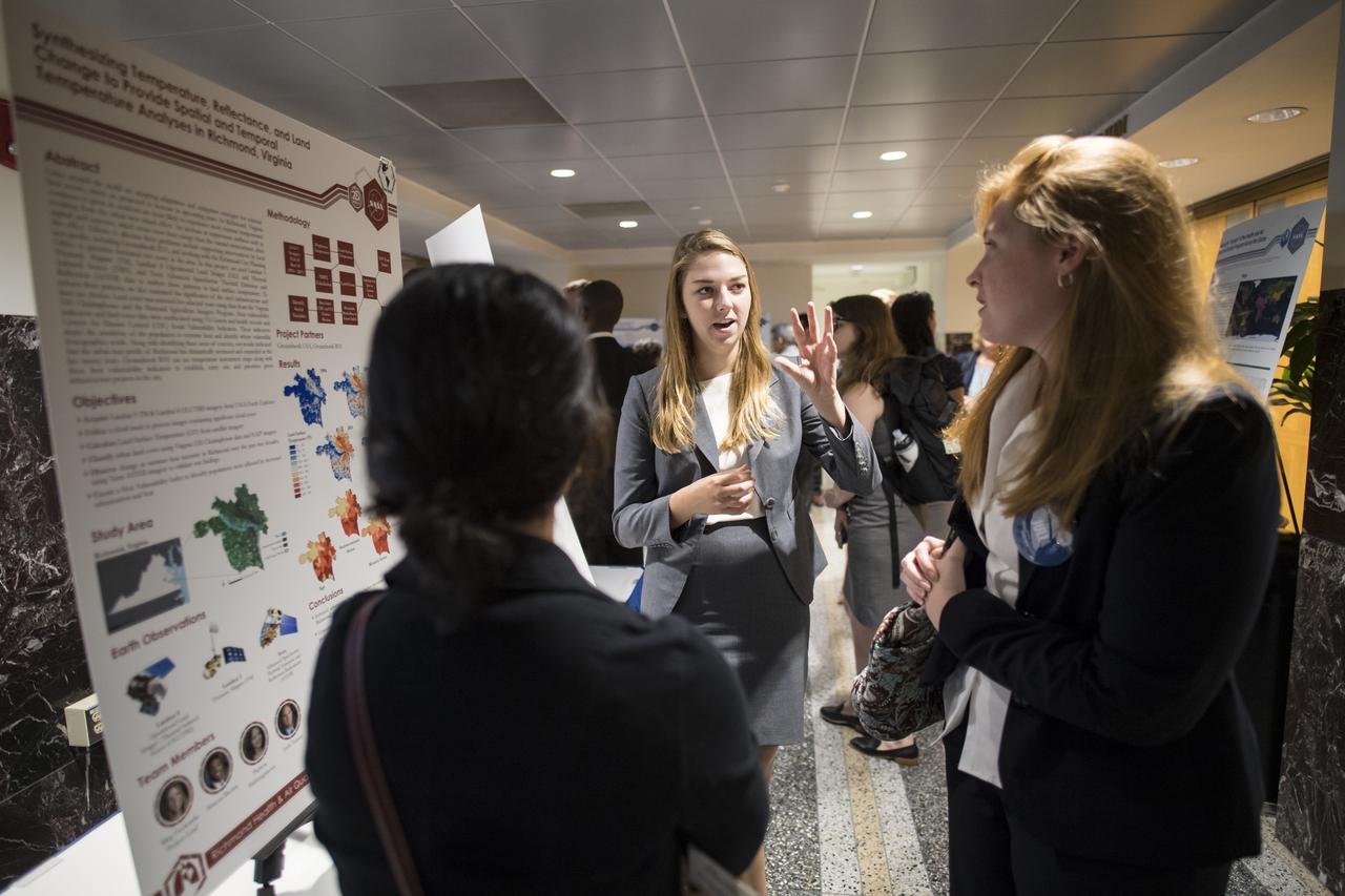 Students and young professionals discuss their projects at the Earth Science Applications Showcase Wednesday, August 1, 2018 at NASA Headquarters in Washington. Every summer, participants in NASA’s Applied Sciences’ DEVELOP National Program come to NASA Headquarters and present their research projects. DEVELOP is a training and development program where students work on Earth science research projects, mentored by science advisers from NASA and partner agencies, and extend research results to local communities. Photo Credit: (NASA/Aubrey Gemignani)