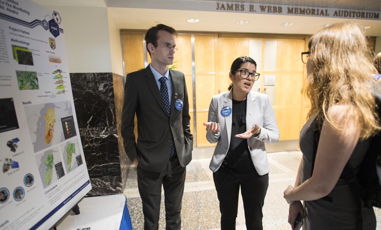 Students and young professionals discuss their projects at the Earth Science Applications Showcase Wednesday, August 1, 2018 at NASA Headquarters in Washington. Every summer, participants in NASA’s Applied Sciences’ DEVELOP National Program come to NASA Headquarters and present their research projects. DEVELOP is a training and development program where students work on Earth science research projects, mentored by science advisers from NASA and partner agencies, and extend research results to local communities. Photo Credit: (NASA/Aubrey Gemignani)