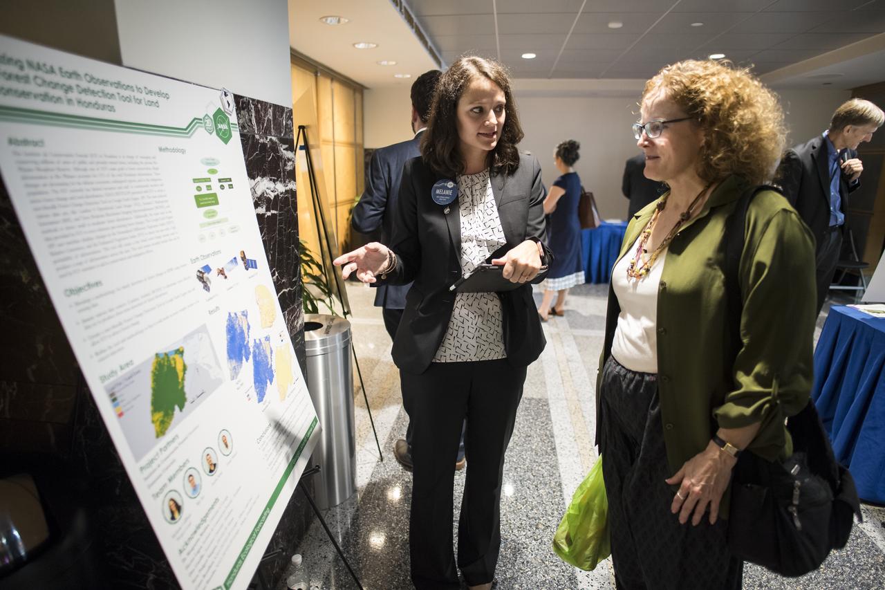 Students and young professionals discuss their projects at the Earth Science Applications Showcase Wednesday, August 1, 2018 at NASA Headquarters in Washington. Every summer, participants in NASA’s Applied Sciences’ DEVELOP National Program come to NASA Headquarters and present their research projects. DEVELOP is a training and development program where students work on Earth science research projects, mentored by science advisers from NASA and partner agencies, and extend research results to local communities. Photo Credit: (NASA/Aubrey Gemignani)