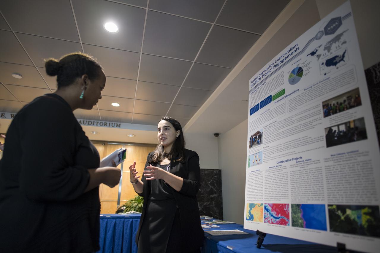Farnaz Bayat from Mobile, Alabama, discusses her project with a participant at the Earth Science Applications Showcase Wednesday, August 1, 2018 at NASA Headquarters in Washington. Farnaz has been with the DEVELOP program since 2016 and has worked on several projects, including her current one using NASA Earth observations to identify areas in New Orleans that are vulnerable to flooding. DEVELOP is a training and development program where students work on Earth science research projects, mentored by science advisers from NASA and partner agencies, and extend research results to local communities. Photo Credit: (NASA/Aubrey Gemignani)