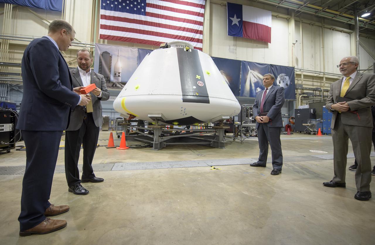 NASA Administrator Jim Bridenstine, left, is shown the Orion test crew capsule that will be used for the Ascent Abort-2 (AA-2) test by Orion AA-2 Crew Module Manager Dr. Jon Olansen, 2nd from left, with Orion Program Manager Mark Kirasich, and NASA Johnson Space Center Director Mark Geyer, right, Thursday, Aug. 2, 2018 at NASA’s Johnson Space Center in Houston, Texas. Photo Credit: (NASA/Bill Ingalls)