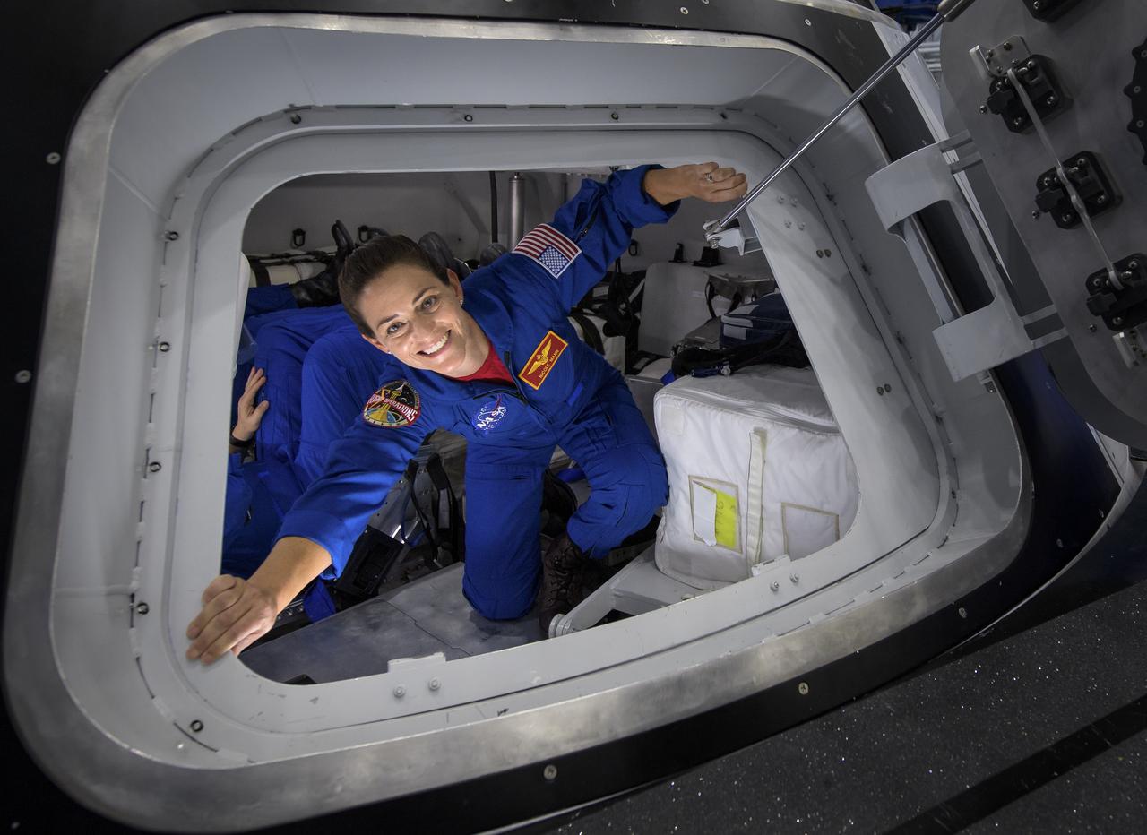 NASA astronaut Nicole Mann poses for a photograph as she exits the Boeing Mockup Trainer at NASA’s Johnson Space Center in Houston, Texas on Aug. 2, 2018 ahead of the commercial crew flight assignments announcement Aug. 3. Mann, along with NASA astronaut Eric Boe and Boeing astronaut Chris Ferguson were assigned to launch aboard Boeing’s CST-100 Starliner on the company’s Crew Flight Test targeted for mid-2019 in partnership with NASA’s Commercial Crew Program. Photo Credit: (NASA/Bill Ingalls)
