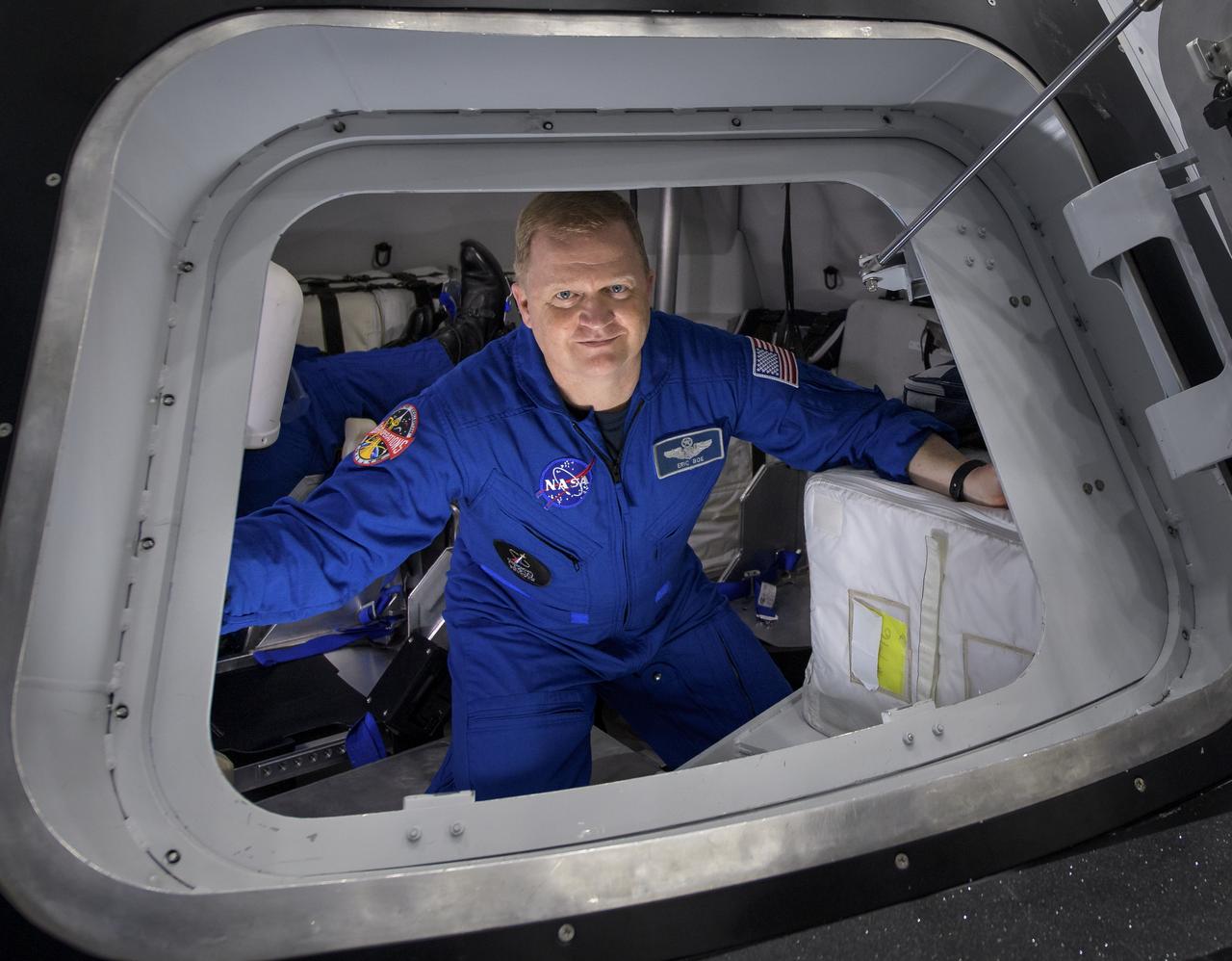 NASA astronaut Eric Boe poses for a photograph as he exits the Boeing Mockup Trainer at NASA’s Johnson Space Center in Houston, Texas on Aug. 2, 2018 ahead of the commercial crew flight assignments announcement Aug. 3. Boe, along with NASA astronaut Nicole Aunapu Mann and Boeing astronaut Chris Ferguson were assigned to launch aboard Boeing’s CST-100 Starliner on the company’s Crew Flight Test targeted for mid-2019 in partnership with NASA’s Commercial Crew Program. Photo Credit: (NASA/Bill Ingalls)