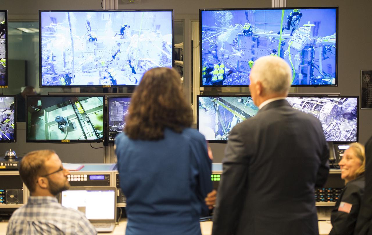 Vice President Mike Pence and NASA astronaut Suni Williams watch on monitors as NASA commercial crew astronauts Victor Glover and Nicole Mann conduct training in the pool at the Neutral Buoyancy Laboratory at NASA's Johnson Space Center during a tour of the facility, Thursday, Aug. 23, 2018 in Houston, Texas.  Photo Credit: (NASA/Joel Kowsky)