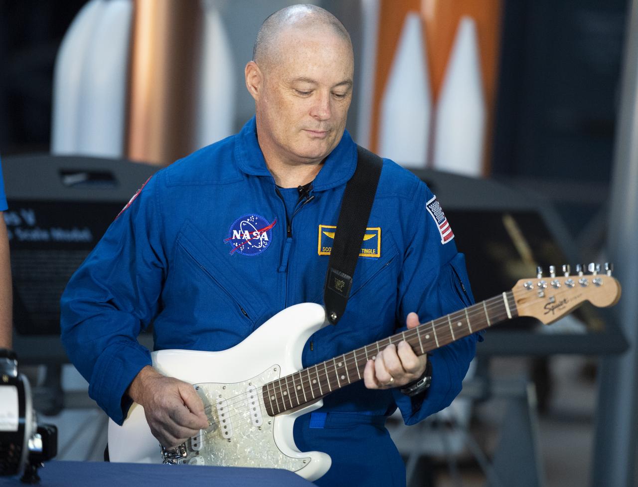 NASA astronaut Scott Tingle plays an electric guitar during a taping of STEM in 30, Wednesday, Sept. 12, 2018 at the Smithsonian National Air and Space Museum's Steven F. Udvar-Hazy Center in Chantilly, Va. Tingle spent 168 days onboard the International Space Station as part of Expeditions 54 and 55. Photo Credit: (NASA/Joel Kowsky)