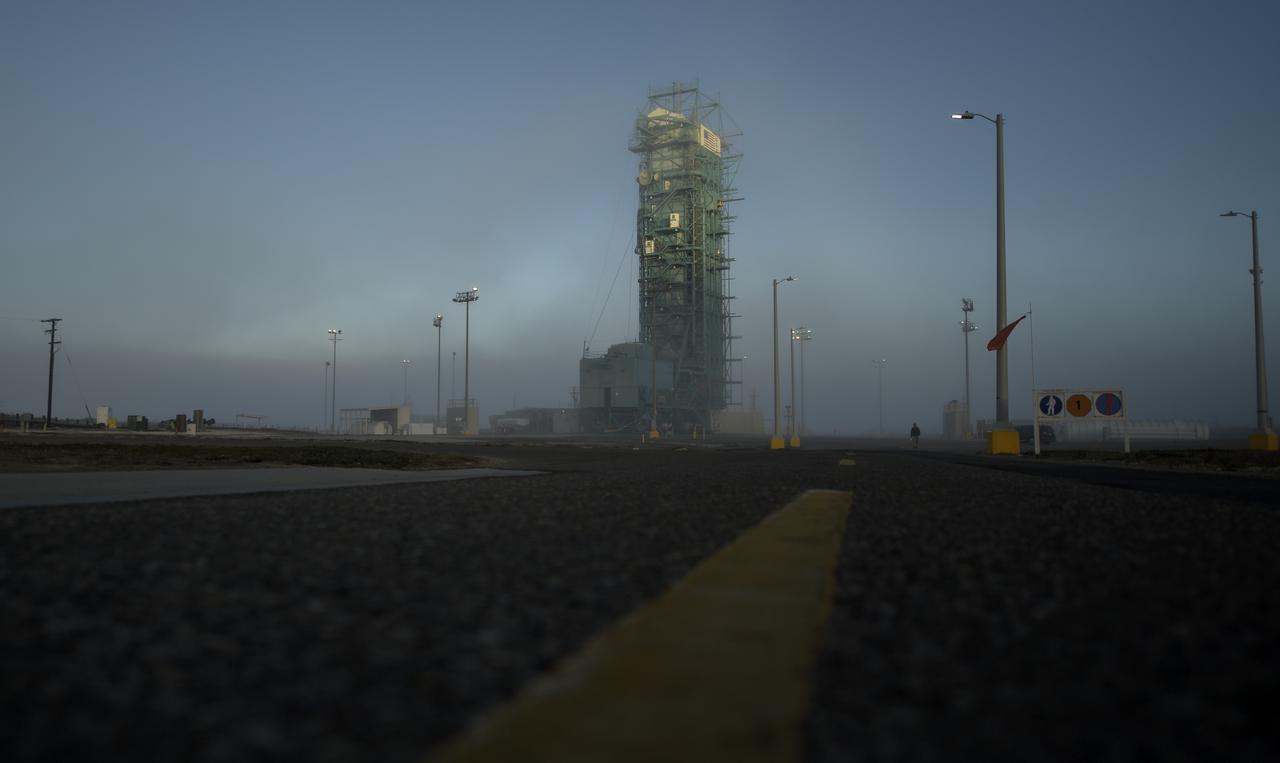 A thin fog covers the mobile service tower and the United Launch Alliance (ULA) Delta II rocket with the NASA Ice, Cloud and land Elevation Satellite-2 (ICESat-2) onboard, Thursday, Sept. 13, 2018, Vandenberg Air Force Base in California. The ICESat-2 mission will measure the changing height of Earth's ice. Photo Credit: (NASA/Bill Ingalls)