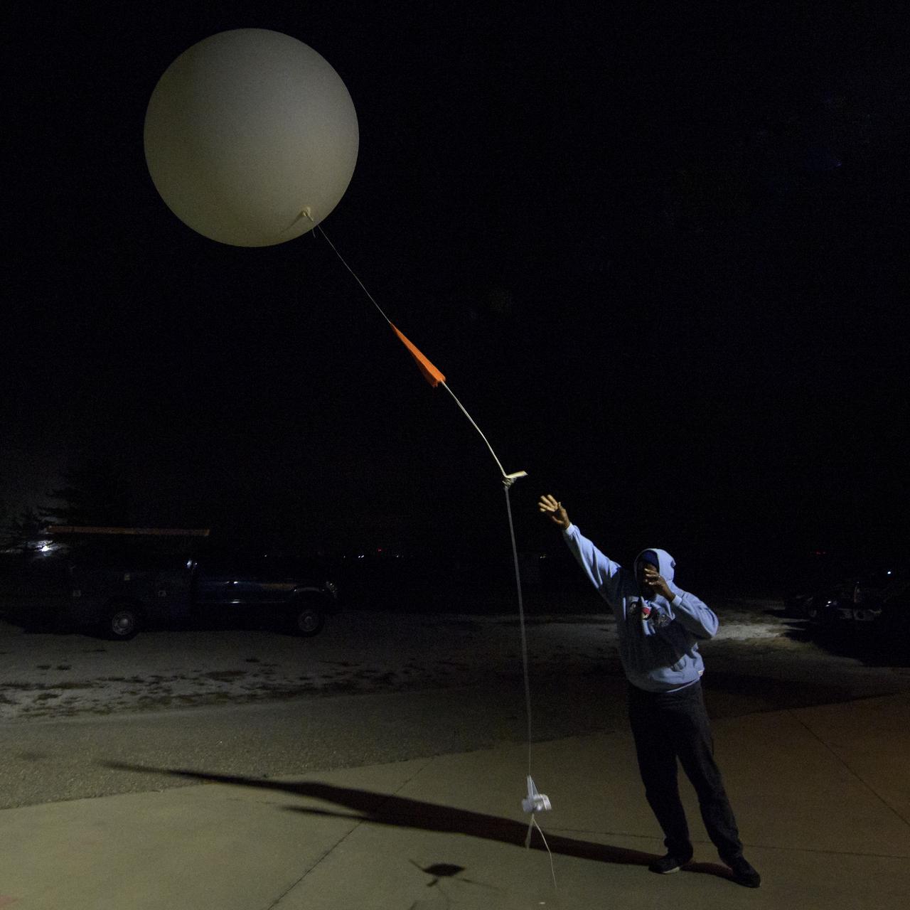 Isiah Toran releases a weather balloon to help measure atmospheric conditions ahead of the launch of the NASA Ice, Cloud and land Elevation Satellite-2 (ICESat-2), Saturday, Sept. 15, 2018, Vandenberg Air Force Base in California. The ICESat-2 mission will measure the changing height of Earth's ice. Photo Credit: (NASA/Bill Ingalls)