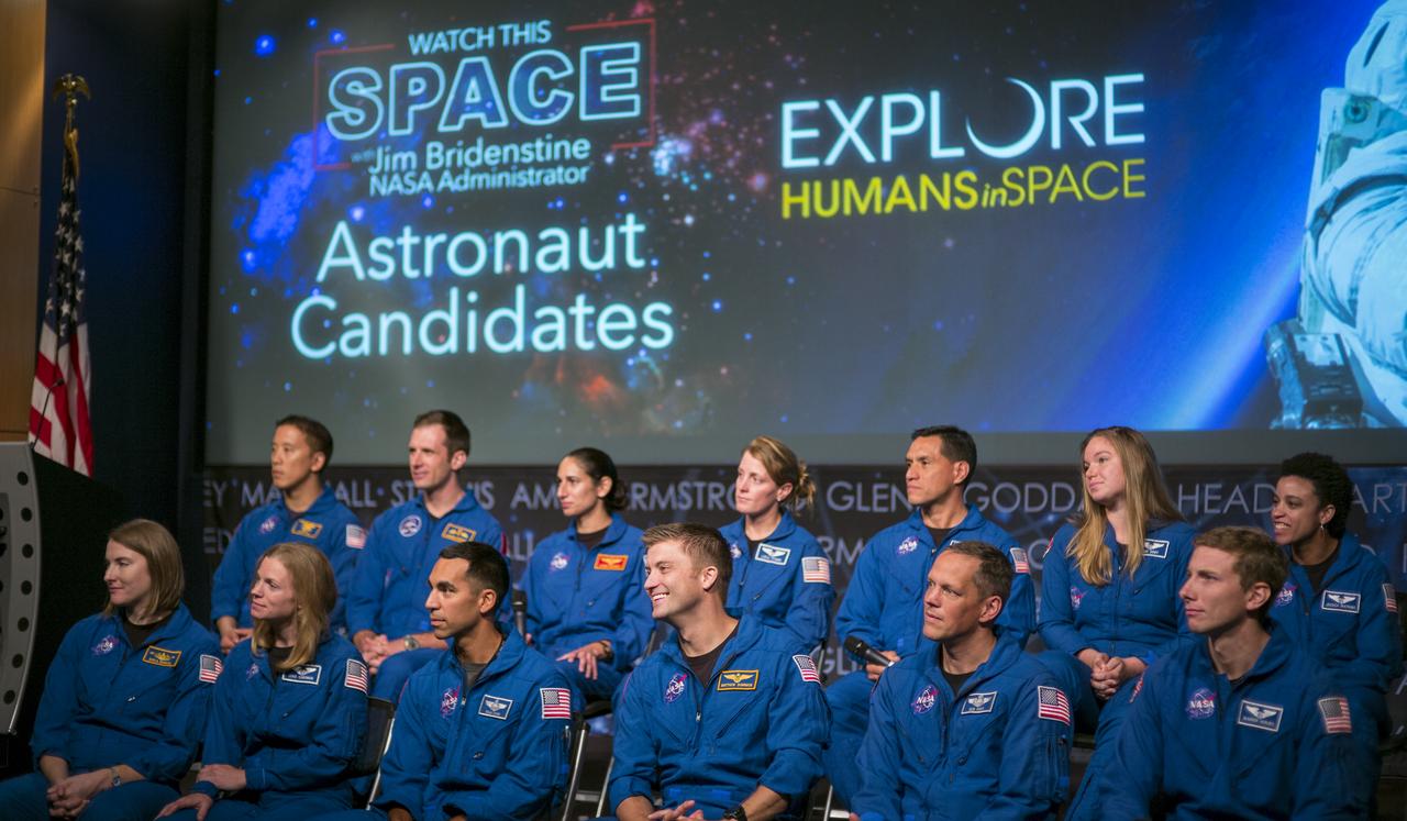 Astronaut candidates, back row from left, Jonny Kim, Joshua Kutryk of the Canadian Space Agency, Jasmin Moghbeli, Loral O’Hara, Frank Rubio, Jennifer Sidey-Gibbons of the Canadian Space Agency, Jessica Watkins, front row from left, Kayla Barron, Zena Cardman, Raja Chari, Matthew Dominick, Bob Hines, and Warren Hoburg are seen during a live episode of the Administrator's monthly chat show, Watch This Space,  Thursday, Sept. 27, 2018 in the Webb Auditorium at NASA Headquarters in Washington. NASA's newest astronaut candidate class has started their two years of training, after which the new astronaut candidates could be assigned to missions performing research on the International Space Station, launching from American soil on spacecraft built by commercial companies, and launching on deep space missions on NASA’s new Orion spacecraft and Space Launch System rocket.  Photo Credit: (NASA/Joel Kowsky)