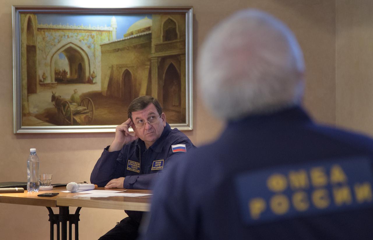 Head of the Search-and-Rescue Department of Rosaviatsiya (Russian Federal Agency for Air Transport) Sergey A. Prusov listens as he leads a meeting with NASA and Roscosmos to discuss the readiness for the landing of Expedition 56 crew members Drew Feustel and Ricky Arnold of NASA, along with Oleg Artemyev of Roscosmos Tuesday, Oct. 2, 2018, at the Cosmonaut Hotel in Karaganda, Kazakhstan. Feustel, Arnold, and Artemyev are returning after 197 days in space where they served as members of the Expedition 55 and 56 crews onboard the International Space Station. Photo Credit: (NASA/Bill Ingalls)