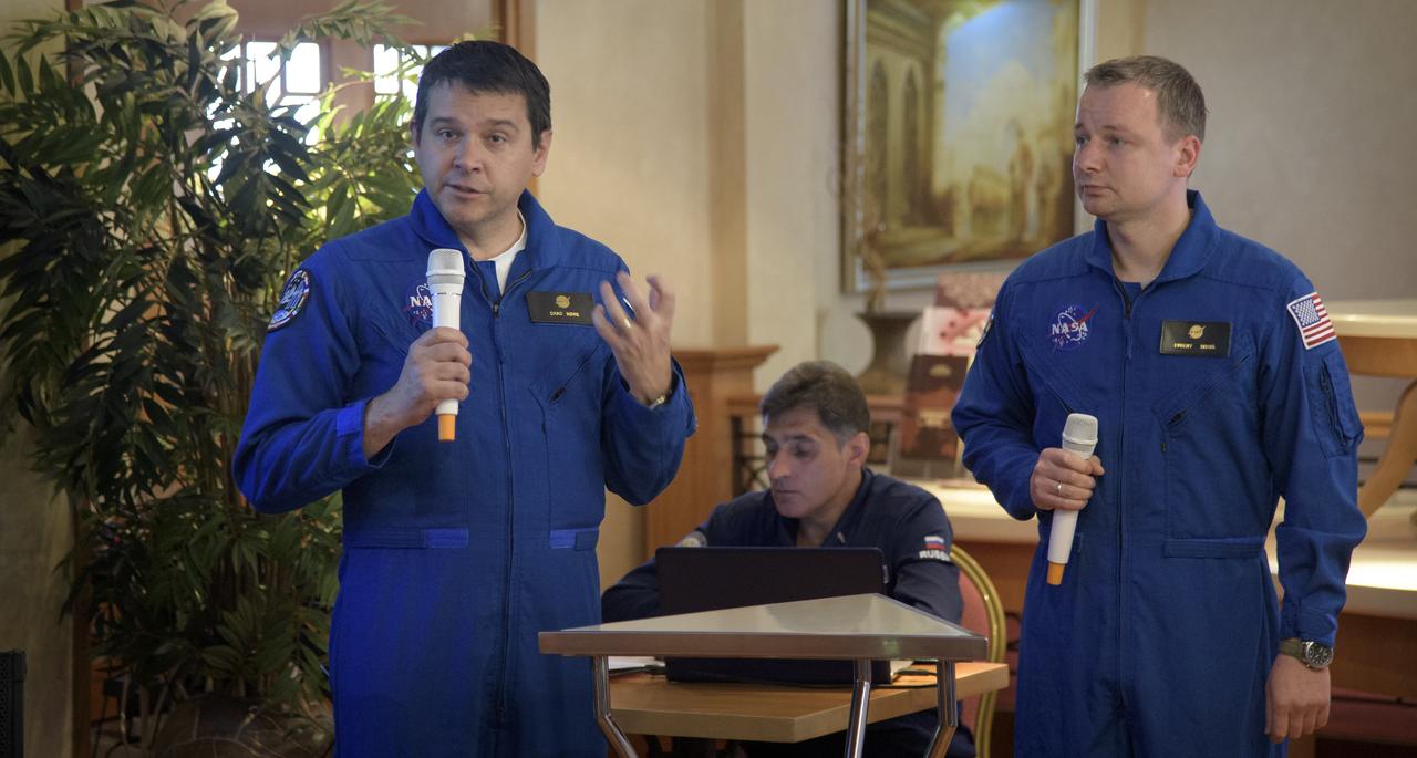 NASA Director for Human Space Flight Programs, Russia, Chad Rowe, left, with the support of NASA Interpreter Evgeny Sokol, gives a report during a meeting of NASA, Roscosmos and Russian Search and Recovery Forces to review the readiness for the landing of Expedition 56 crew members Drew Feustel and Ricky Arnold of NASA, along with Oleg Artemyev of Roscosmos Tuesday, Oct. 2, 2018, at the Cosmonaut Hotel in Karaganda, Kazakhstan. Feustel, Arnold, and Artemyev are returning after 197 days in space where they served as members of the Expedition 55 and 56 crews onboard the International Space Station. Photo Credit: (NASA/Bill Ingalls)
