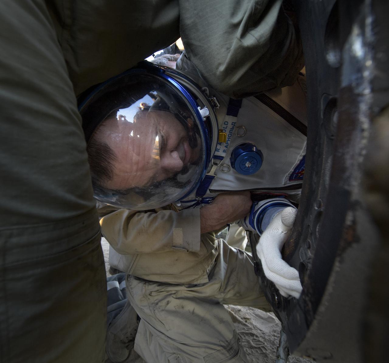 Expedition 56 Flight Engineer Ricky Arnold of NASA is helped out of the Soyuz MS-08 spacecraft just minutes after he, Expedition 56 Commander Drew Feustel of NASA, and Flight Engineer and Soyuz Commander Oleg Artemyev of Roscosmos, landed in a remote area near the town of Zhezkazgan, Kazakhstan on Thursday, Oct. 4, 2018. Feustel, Arnold, and Artemyev are returning after 197 days in space where they served as members of the Expedition 55 and 56 crews onboard the International Space Station. Photo Credit: (NASA/Bill Ingalls)