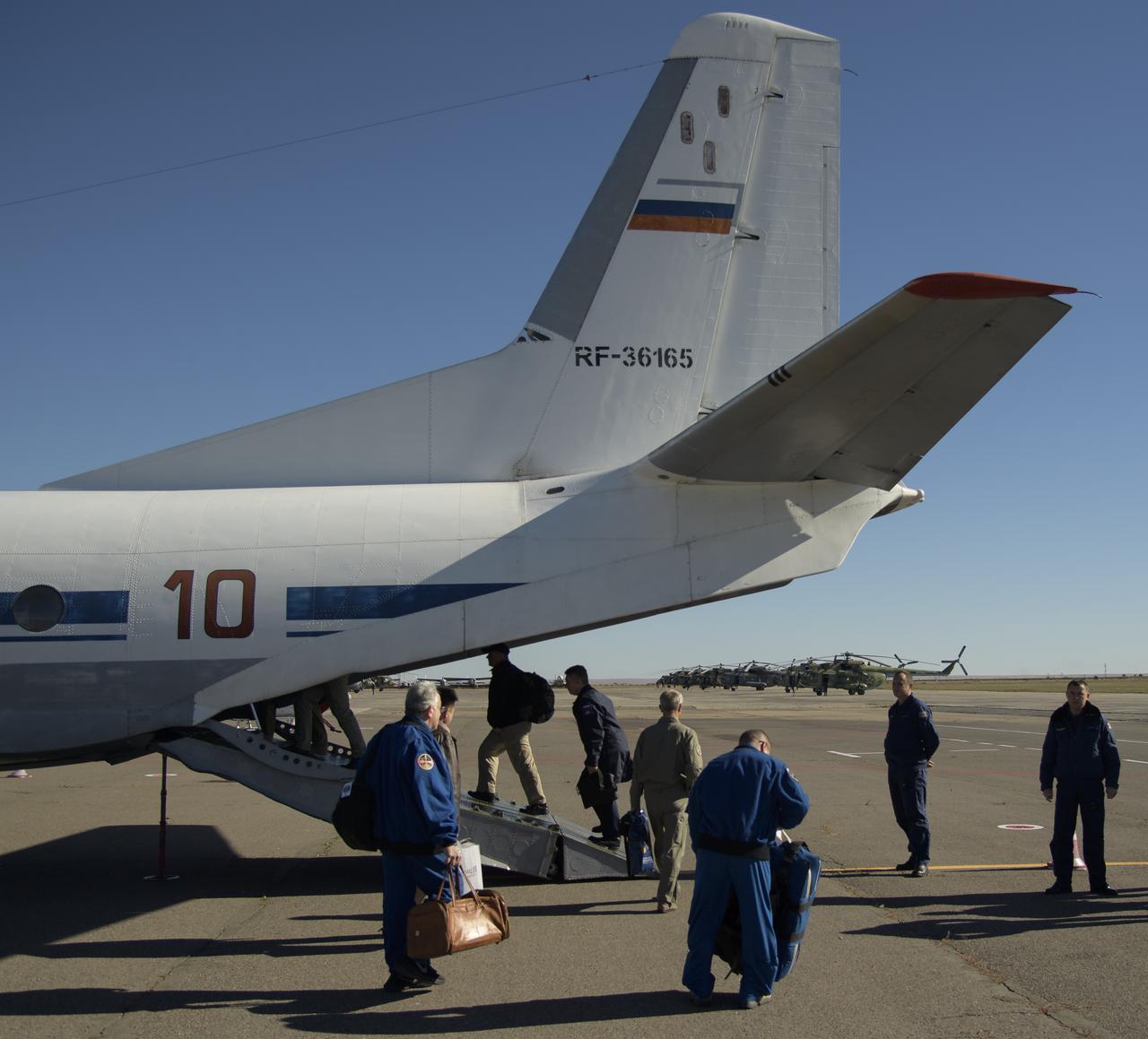 NASA, Roscosmos and Russian Search and Rescue teams board an AN-26 aircraft at the Karaganda Airport in Kazakhstan and fly to Zhezkazgan to be in place for the Soyuz MS-08 spacecraft landing with Expedition 56 Commander Drew Feustel and Flight Engineer Ricky Arnold of NASA, along with Flight Engineer and Soyuz Commander Oleg Artemyev of Roscosmos on Thursday, Oct. 4, 2018. Feustel, Arnold, and Artemyev are returning after 197 days in space where they served as members of the Expedition 55 and 56 crews onboard the International Space Station. Photo Credit: (NASA/Bill Ingalls)