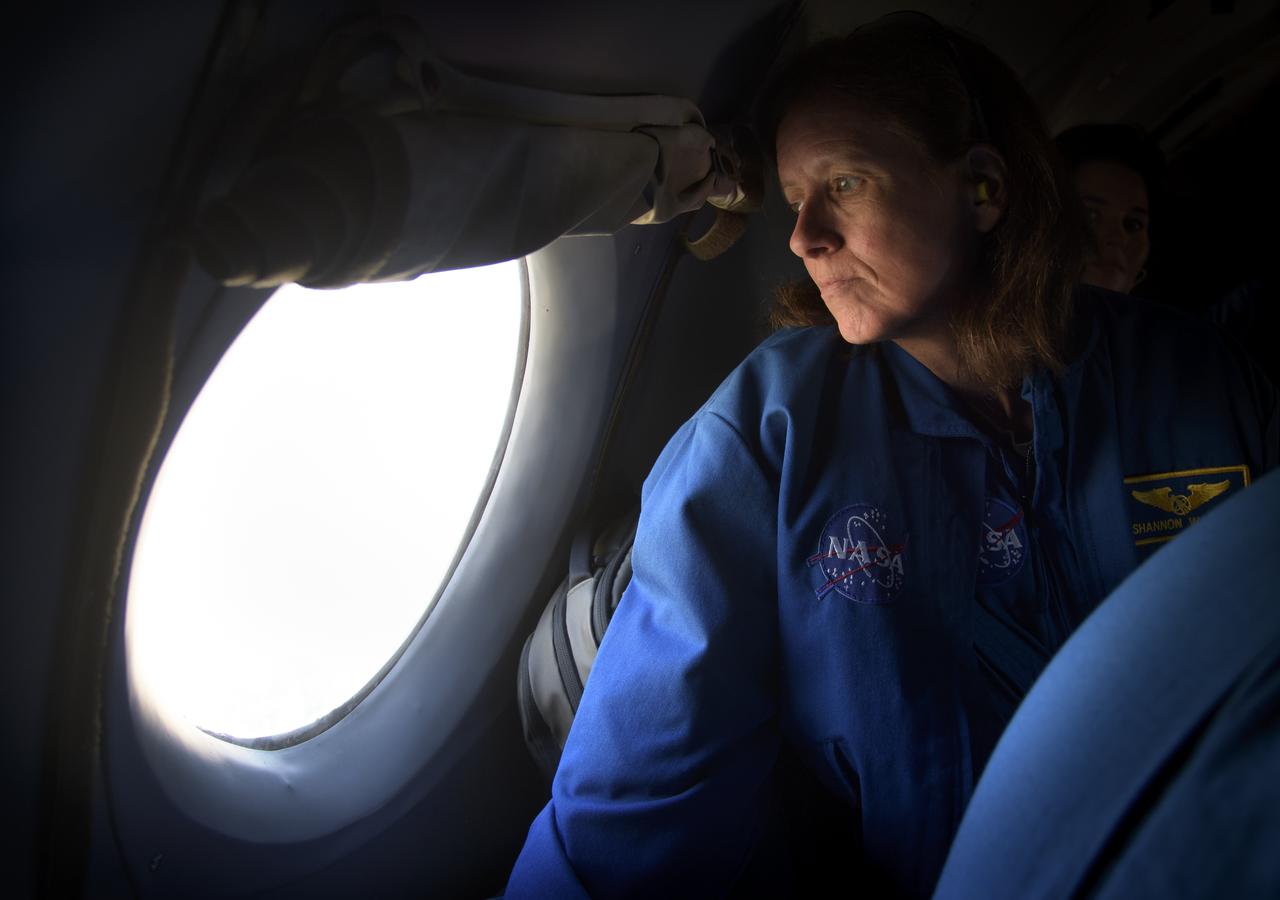 NASA astronaut and Astronaut Office Representative Shannon Walker looks out the window while onboard an AN-26 aircraft taking her and other support personnel to the Zhezkazgan Airport in Kazakhstan for the Soyuz MS-08 spacecraft landing with Expedition 56 Commander Drew Feustel and Flight Engineer Ricky Arnold of NASA, along with Flight Engineer and Soyuz Commander Oleg Artemyev of Roscosmos on Thursday, Oct. 4, 2018. Feustel, Arnold, and Artemyev are returning after 197 days in space where they served as members of the Expedition 55 and 56 crews onboard the International Space Station. Photo Credit: (NASA/Bill Ingalls)