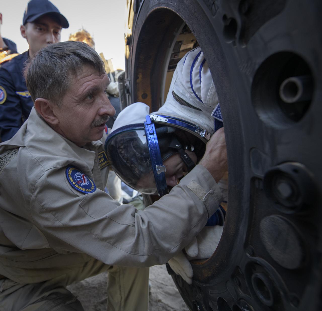 Expedition 56 Commander Drew Feustel of NASA is helped out of the Soyuz MS-08 spacecraft just minutes after he, Expedition 56 Flight Engineer Ricky Arnold of NASA, and Expedition 56 Flight Engineer and Soyuz Commander Oleg Artemyev of Roscosmos, landed in a remote area near the town of Zhezkazgan, Kazakhstan on Thursday, Oct. 4, 2018. Feustel, Arnold, and Artemyev are returning after 197 days in space where they served as members of the Expedition 55 and 56 crews onboard the International Space Station. Photo Credit: (NASA/Bill Ingalls)