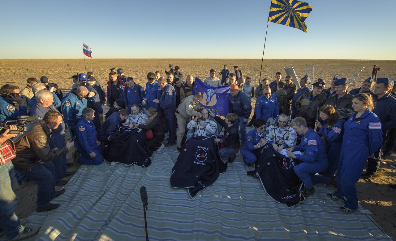 Expedition 56 Flight Engineer Ricky Arnold of NASA, left, Expedition 56 Flight Engineer and Soyuz Commander Oleg Artemyev of Roscosmos, center, and Expedition 56 Commander Drew Feustel of NASA sit in chairs outside the Soyuz MS-08 spacecraft after they landed in a remote area near the town of Zhezkazgan, Kazakhstan on Thursday, Oct. 4, 2018. Feustel, Arnold, and Artemyev are returning after 197 days in space where they served as members of the Expedition 55 and 56 crews onboard the International Space Station. Photo Credit: (NASA/Bill Ingalls)