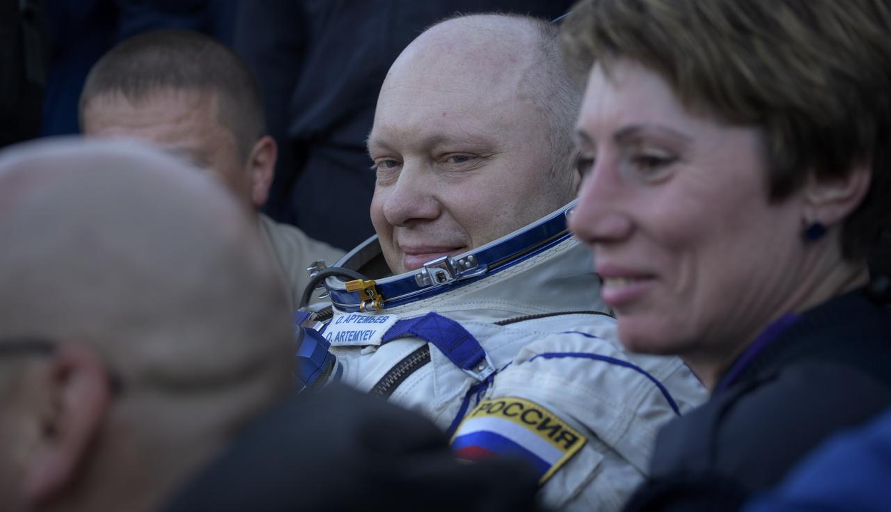 Expedition 56 Flight Engineer and Soyuz Commander Oleg Artemyev of Roscosmos rests outside the Soyuz Capsule after he, Expedition 56 Flight Engineer Ricky Arnold of NASA, and Expedition 56 Commander Drew Feustel of NASA landed in a remote area near the town of Zhezkazgan, Kazakhstan on Thursday, Oct. 4, 2018. Feustel, Arnold, and Artemyev are returning after 197 days in space where they served as members of the Expedition 55 and 56 crews onboard the International Space Station. Photo Credit: (NASA/Bill Ingalls)